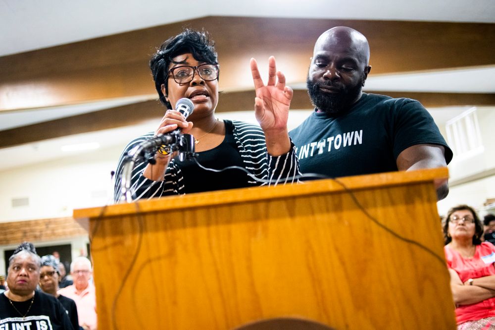 April Cook-Hawkins, center left, and her husband Jeff Hawkins stand together as they address Michigan Solicitor General Fadwa Hammoud and Wayne County Prosecutor Kym Worthy during a community meeting with Flint water prosecutors at UAW Local 659, Friday, June 28, 2019, in Flint, Mich. Hammoud and Worthy spoke to the residents, two weeks after dismissing charges against the former state health director and other officials. (Jake May/MLive.com/The Flint Journal via AP) April Cook-Hawkins, center left, and her husband Jeff Hawkins stand together as they address Michigan Solicitor General Fadwa Hammoud and Wayne County Prosecutor Kym Worthy during a community meeting with Flint water prosecutors at UAW Local 659, Friday, June 28, 2019, in Flint, Mich. Hammoud and Worthy spoke to the residents, two weeks after dismissing charges against the former state health director and other officials. (Jake May/MLive.com/The Flint Journal via AP)