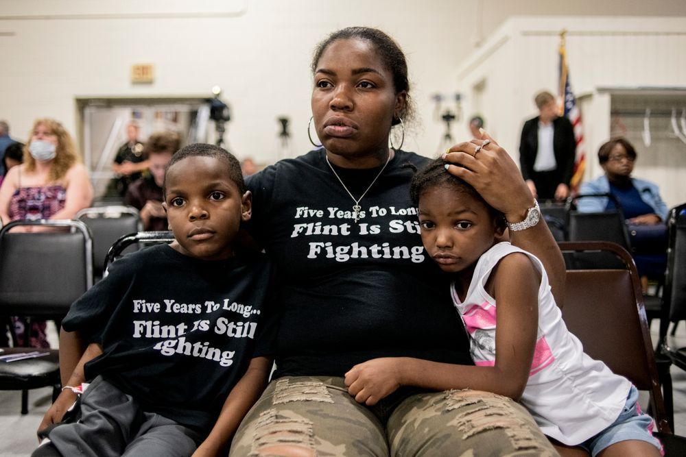 Flint resident Ariana Hawk consoles her son Sincere Smith, left, and Aliana Hawk, 4, nearing the end of a two-hour community meeting with Flint water prosecutors at UAW Local 659, Friday, June 28, 2019, in Flint, Mich. Sincere Smith graced the cover of Time magazine at the height of the Flint water crisis in 2016. Michigan Solicitor General Fadwa Hammoud and Wayne County Prosecutor Kym Worthy spoke to residents Friday night, two weeks after dismissing charges against the former state health director and other officials. (Jake May/MLive.com/The Flint Journal via AP) Flint resident Ariana Hawk consoles her son Sincere Smith, left, and Aliana Hawk, 4, nearing the end of a two-hour community meeting with Flint water prosecutors at UAW Local 659, Friday, June 28, 2019, in Flint, Mich. Sincere Smith graced the cover of Time magazine at the height of the Flint water crisis in 2016. Michigan Solicitor General Fadwa Hammoud and Wayne County Prosecutor Kym Worthy spoke to residents Friday night, two weeks after dismissing charges against the former state health director and other officials. (Jake May/MLive.com/The Flint Journal via AP)