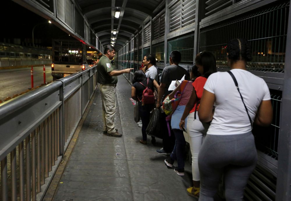 FILE - In this Sept. 17, 2019, file photo, a Mexican immigration officer gives instructions to migrants who are applying for asylum in U.S. as they wait on International Bridge 1 as they prepare to leave Nuevo Laredo, Mexico, and enter Laredo, Texas. Mexicans are increasingly the face of asylum in the United States, replacing Central Americans who dominated last year's caravan and a surge of families that brought border arrests to a 13-year high in May. It is unclear precisely what is driving the change, perhaps a mix of U.S. policies and violence in Mexico. U.S. Customs and Border Protection figures show fewer Mexicans are crossing, but the drop in Central Americans is much sharper, making Mexicans a bigger part of the mix. (AP Photo/Fernando Llano, File) FILE - In this Sept. 17, 2019, file photo, a Mexican immigration officer gives instructions to migrants who are applying for asylum in U.S. as they wait on International Bridge 1 as they prepare to leave Nuevo Laredo, Mexico, and enter Laredo, Texas. Mexicans are increasingly the face of asylum in the United States, replacing Central Americans who dominated last year's caravan and a surge of families that brought border arrests to a 13-year high in May. It is unclear precisely what is driving the change, perhaps a mix of U.S. policies and violence in Mexico. U.S. Customs and Border Protection figures show fewer Mexicans are crossing, but the drop in Central Americans is much sharper, making Mexicans a bigger part of the mix. (AP Photo/Fernando Llano, File)