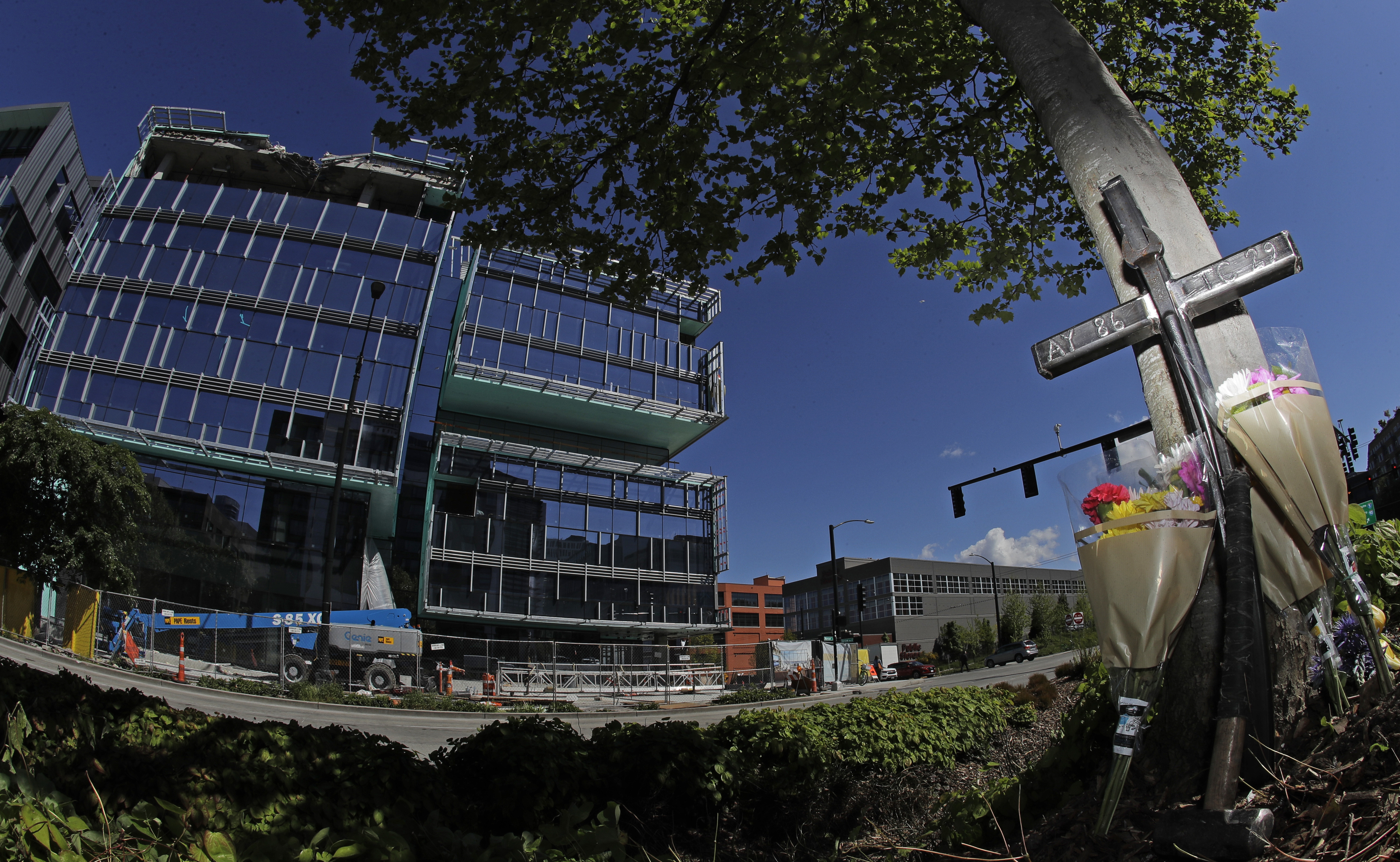 An iron cross bearing the numbers of Ironworkers Local union chapters from Portland and Seattle stands next to flowers, Monday, April 29, 2019, at a memorial on a median across the street from where a construction crane collapsed and fell Saturday, killing four people, two of whom were ironworkers. (AP Photo/Ted S. Warren) An iron cross bearing the numbers of Ironworkers Local union chapters from Portland and Seattle stands next to flowers, Monday, April 29, 2019, at a memorial on a median across the street from where a construction crane collapsed and fell Saturday, killing four people, two of whom were ironworkers. (AP Photo/Ted S. Warren)