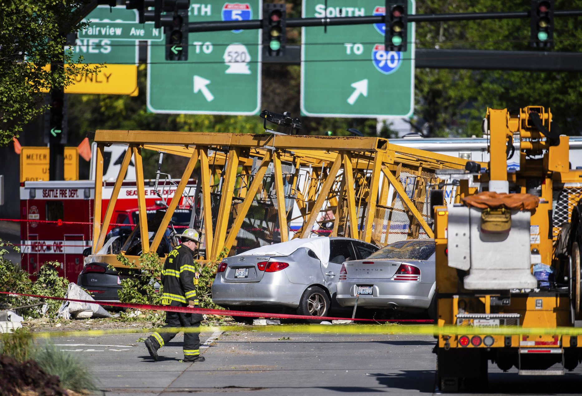Emergency crews work the scene of a construction crane collapse near the intersection of Mercer Street and Fairview Avenue near Interstate 5 in Seattle, on Saturday, April 27, 2019. The crane was atop an office building under construction in a densely populated area. Authorities say several people have died and a few others are hospitalized after the construction crane fell onto a street in downtown Seattle pinning cars underneath on Saturday afternoon. (Joshua Bessex/The News Tribune via AP) Emergency crews work the scene of a construction crane collapse near the intersection of Mercer Street and Fairview Avenue near Interstate 5 in Seattle, on Saturday, April 27, 2019. The crane was atop an office building under construction in a densely populated area. Authorities say several people have died and a few others are hospitalized after the construction crane fell onto a street in downtown Seattle pinning cars underneath on Saturday afternoon. (Joshua Bessex/The News Tribune via AP)
