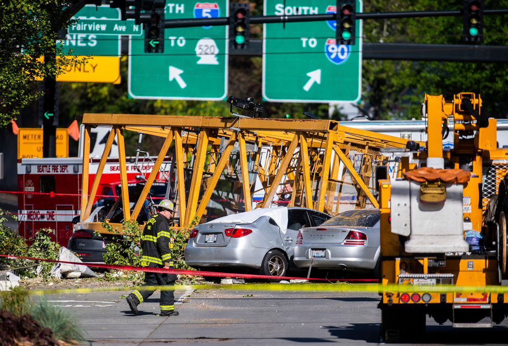 Emergency crews work the scene of a construction crane collapse near the intersection of Mercer Street and Fairview Avenue near Interstate 5 in Seattle, on Saturday, April 27, 2019. The crane was atop an office building under construction in a densely populated area. Authorities say several people have died and a few others are hospitalized after the construction crane fell onto a street in downtown Seattle pinning cars underneath on Saturday afternoon. (Joshua Bessex/The News Tribune via AP) Emergency crews work the scene of a construction crane collapse near the intersection of Mercer Street and Fairview Avenue near Interstate 5 in Seattle, on Saturday, April 27, 2019. The crane was atop an office building under construction in a densely populated area. Authorities say several people have died and a few others are hospitalized after the construction crane fell onto a street in downtown Seattle pinning cars underneath on Saturday afternoon. (Joshua Bessex/The News Tribune via AP)