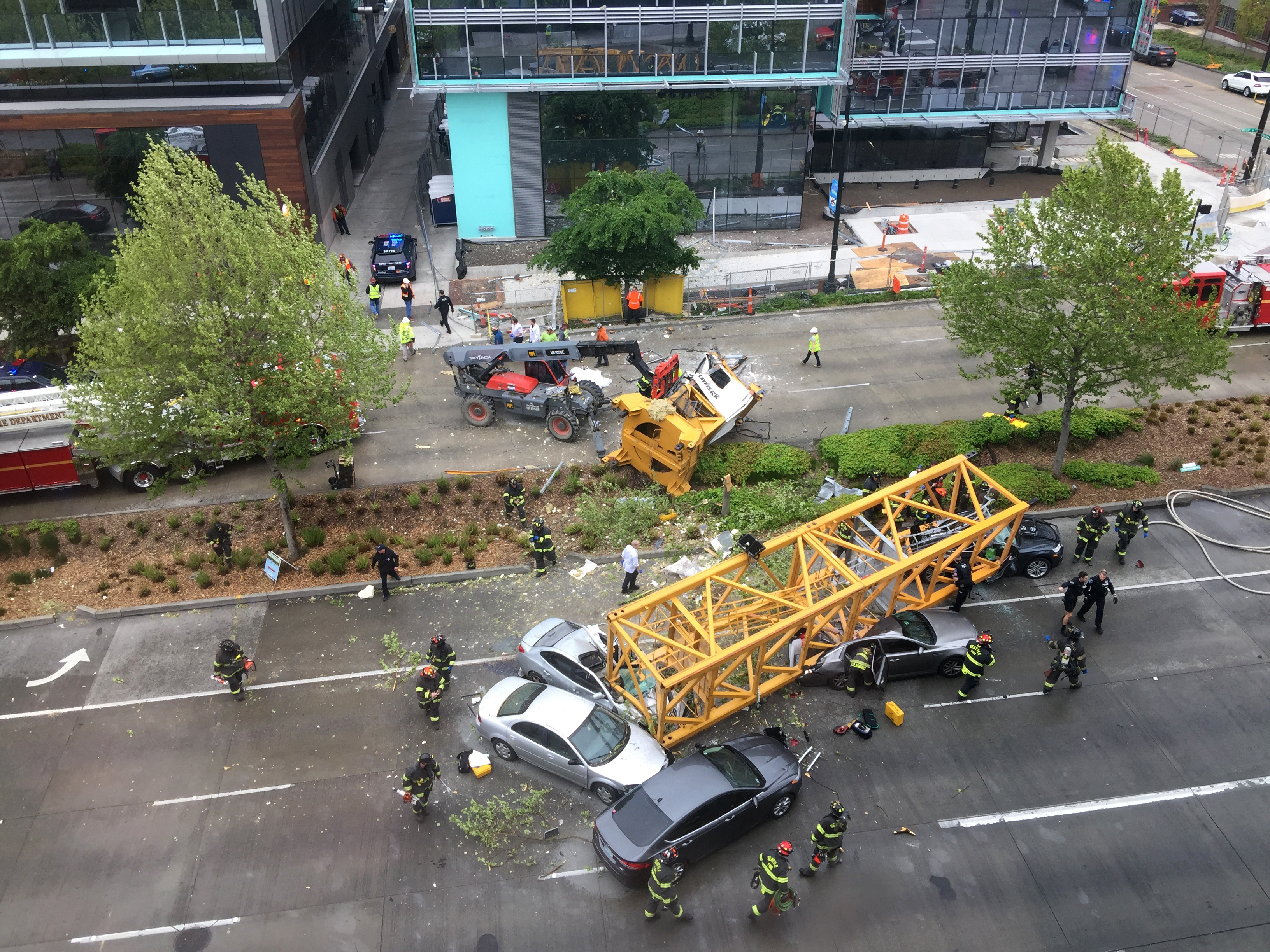 Fire and police crew members work to clear the scene where a construction crane fell from a building on Google's new Seattle campus crashing down onto one of the city's busiest streets and killing multiple people on Saturday, April 27, 2019. (AP Photo/Frank Kuin) Fire and police crew members work to clear the scene where a construction crane fell from a building on Google's new Seattle campus crashing down onto one of the city's busiest streets and killing multiple people on Saturday, April 27, 2019. (AP Photo/Frank Kuin)