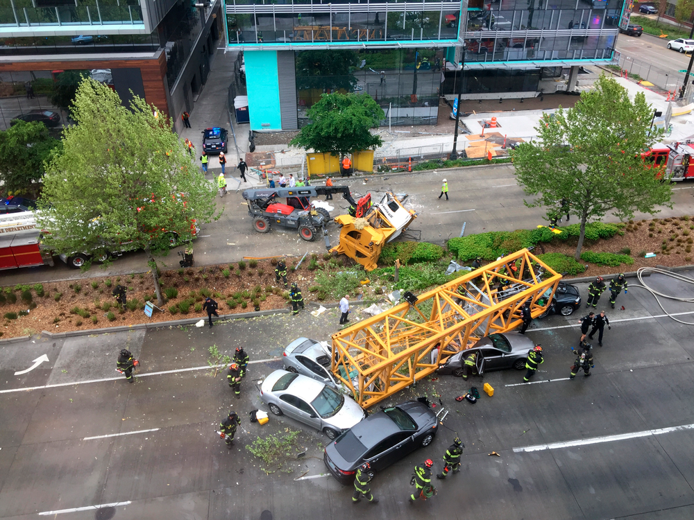 Fire and police crew members work to clear the scene where a construction crane fell from a building on Google's new Seattle campus crashing down onto one of the city's busiest streets and killing multiple people on Saturday, April 27, 2019. (AP Photo/Frank Kuin) Fire and police crew members work to clear the scene where a construction crane fell from a building on Google's new Seattle campus crashing down onto one of the city's busiest streets and killing multiple people on Saturday, April 27, 2019. (AP Photo/Frank Kuin)