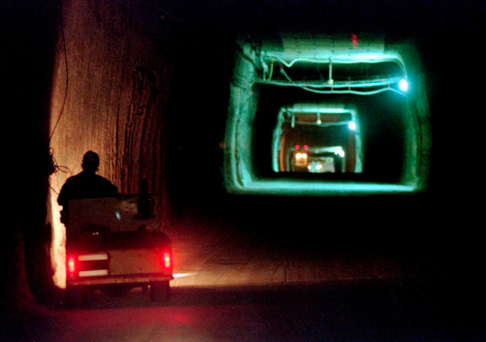 FILE - In this April 8, 1998, file photo, a worker drives a cart through a tunnel inside the Waste Isolation Pilot Plant No. 2, 150 feet below the surface near Carlsbad, N.M. Twenty years and more than 12,330 shipments later, tons of Cold War-era radioactive waste from decades of bomb-making and research have been stashed in the salt caverns that make up the underground facility and not without issues. (AP Photo/Eric Draper, File) FILE - In this April 8, 1998, file photo, a worker drives a cart through a tunnel inside the Waste Isolation Pilot Plant No. 2, 150 feet below the surface near Carlsbad, N.M. Twenty years and more than 12,330 shipments later, tons of Cold War-era radioactive waste from decades of bomb-making and research have been stashed in the salt caverns that make up the underground facility and not without issues. (AP Photo/Eric Draper, File)