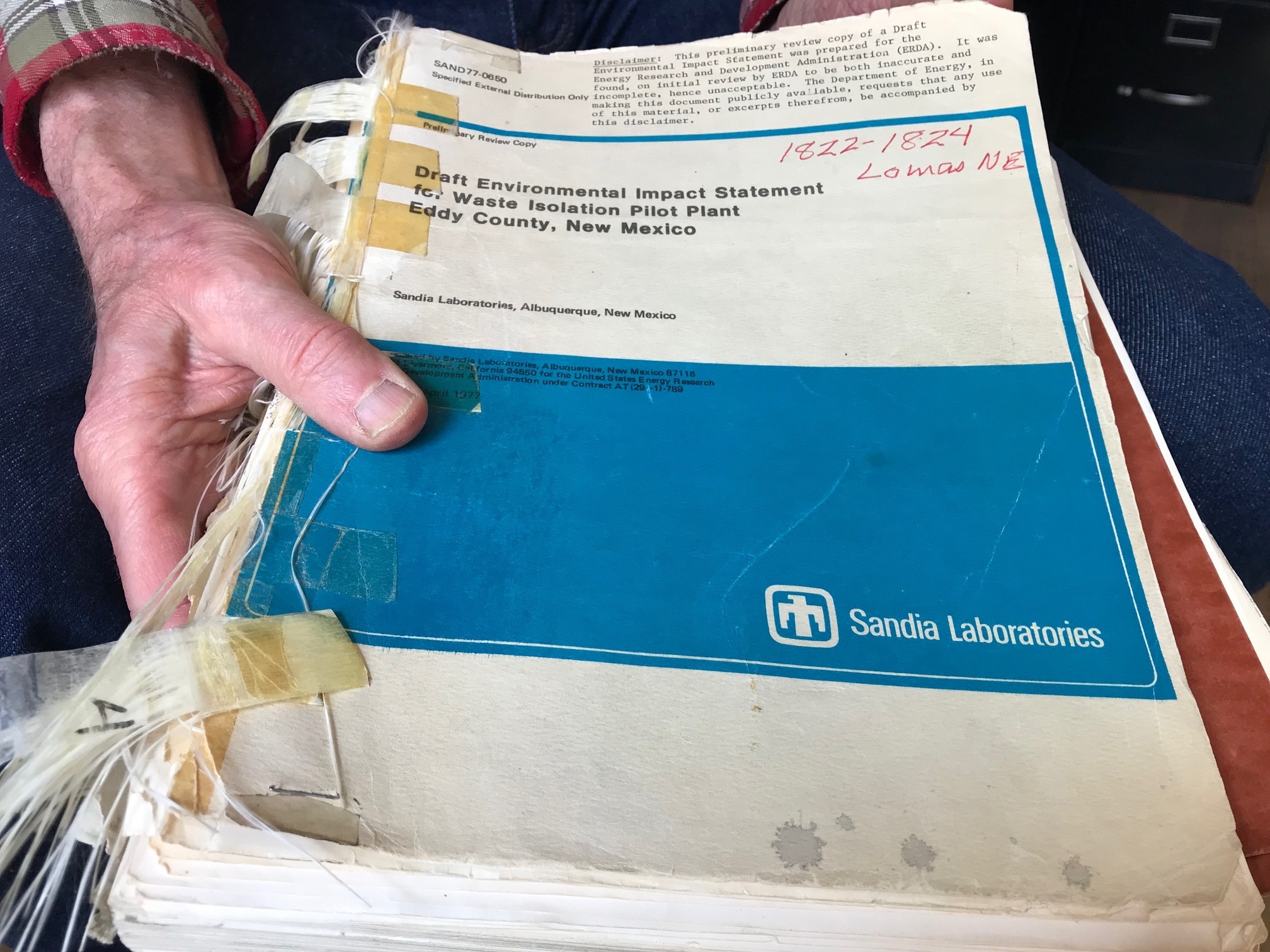 In this March 5, 2019 photo, Don Hancock of the Southwest Research and Information Center holds an early draft copy of an environmental review related to the Waste Isolation Pilot Plant that was planned for southern New Mexico. The underground nuclear repository has been in operation for 20 years, having received its first shipment of waste on March 26, 1999. (AP Photo/Susan Montoya Bryan) In this March 5, 2019 photo, Don Hancock of the Southwest Research and Information Center holds an early draft copy of an environmental review related to the Waste Isolation Pilot Plant that was planned for southern New Mexico. The underground nuclear repository has been in operation for 20 years, having received its first shipment of waste on March 26, 1999. (AP Photo/Susan Montoya Bryan)