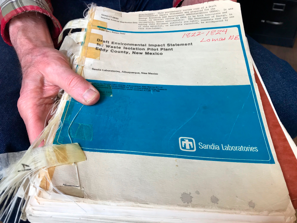 In this March 5, 2019 photo, Don Hancock of the Southwest Research and Information Center holds an early draft copy of an environmental review related to the Waste Isolation Pilot Plant that was planned for southern New Mexico. The underground nuclear repository has been in operation for 20 years, having received its first shipment of waste on March 26, 1999. (AP Photo/Susan Montoya Bryan) In this March 5, 2019 photo, Don Hancock of the Southwest Research and Information Center holds an early draft copy of an environmental review related to the Waste Isolation Pilot Plant that was planned for southern New Mexico. The underground nuclear repository has been in operation for 20 years, having received its first shipment of waste on March 26, 1999. (AP Photo/Susan Montoya Bryan)