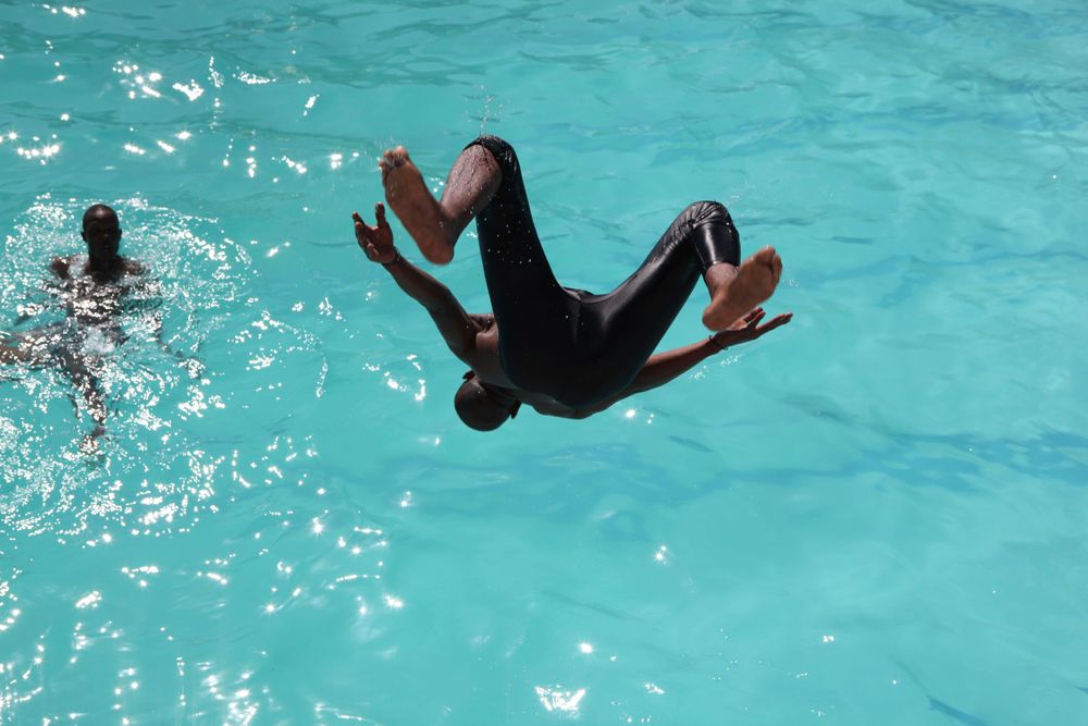 FILE - In this Friday, Jan. 17, 2014 file photo, people cool off in a public pool in Soweto, South Africa during exterme heat conditions in parts of the country. South Africa's government is announcing water restrictions as reservoir levels drop and rainfall is not expected until December. Lindiwe Sisulu, the country’s water and sanitation minister, says Monday, Oct. 28, 2019 that many parts of South Africa are facing water scarcities as summer arrives in the Southern Hemisphere and climate change brings hotter, drier days. (AP Photo/Denis Farrell/File) FILE - In this Friday, Jan. 17, 2014 file photo, people cool off in a public pool in Soweto, South Africa during exterme heat conditions in parts of the country. South Africa's government is announcing water restrictions as reservoir levels drop and rainfall is not expected until December. Lindiwe Sisulu, the country’s water and sanitation minister, says Monday, Oct. 28, 2019 that many parts of South Africa are facing water scarcities as summer arrives in the Southern Hemisphere and climate change brings hotter, drier days. (AP Photo/Denis Farrell/File)