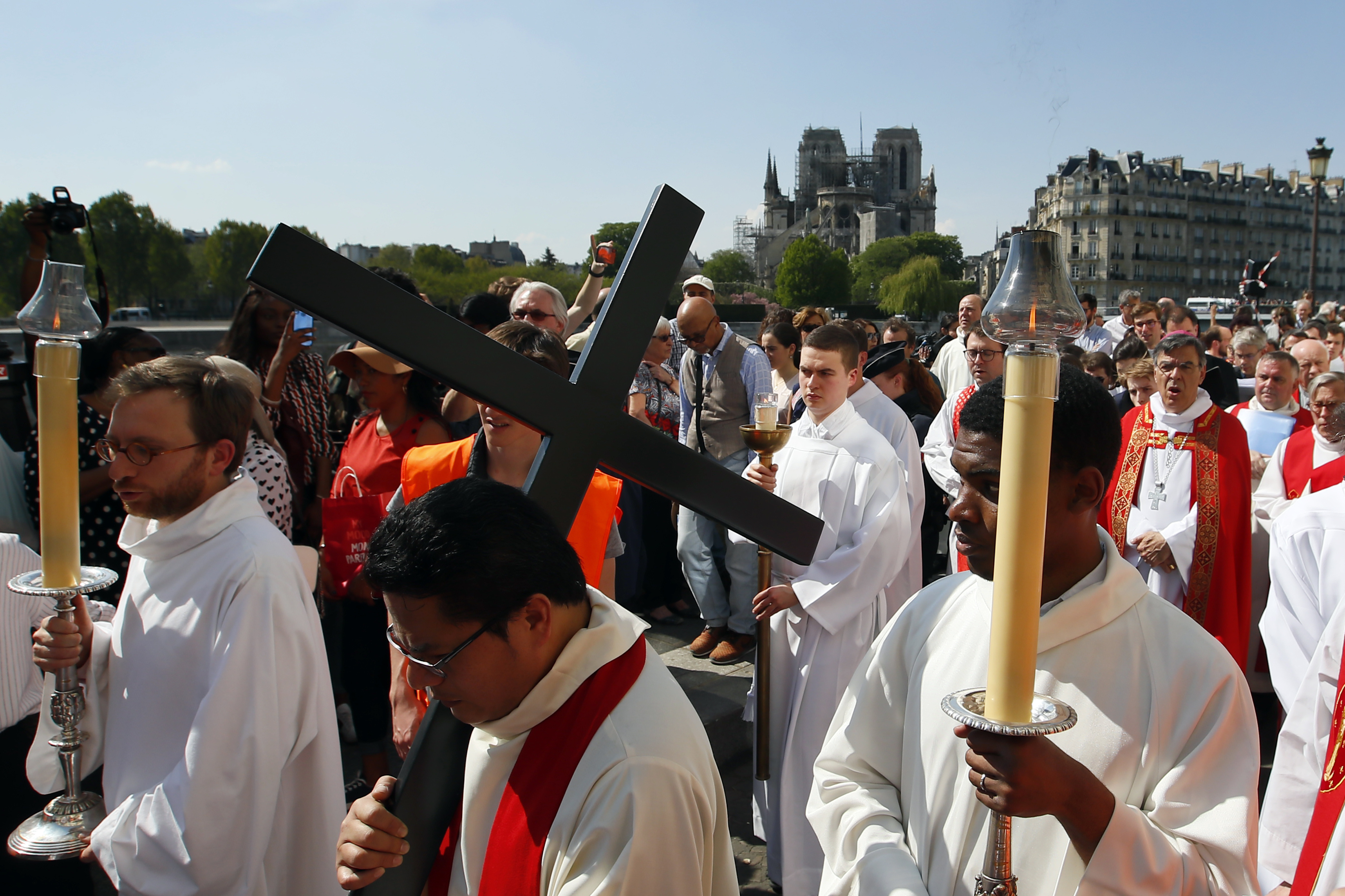 With Notre Dame cathedral in background, religious officials carry the cross during the Good Friday procession, Friday, April 19, 2019 in Paris. Top French art conservation officials say the works inside Notre Dame suffered no major damage in the fire that devastated the cathedral, and the pieces have been removed from the building for their protection.(AP Photo/Francois Mori) With Notre Dame cathedral in background, religious officials carry the cross during the Good Friday procession, Friday, April 19, 2019 in Paris. Top French art conservation officials say the works inside Notre Dame suffered no major damage in the fire that devastated the cathedral, and the pieces have been removed from the building for their protection.(AP Photo/Francois Mori)