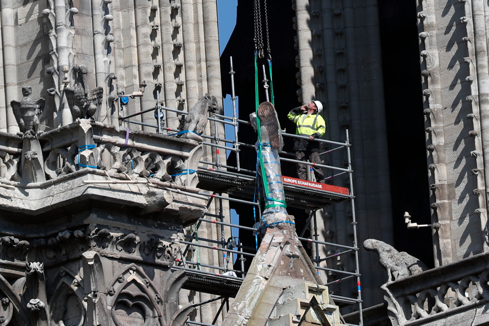 A worker prepares to remove a statue from the damaged Notre Dame cathedral, in Paris, Friday, April 19, 2019. Rebuilding Notre Dame, the 800-year-old Paris cathedral devastated by fire this week, will cost billions of dollars as architects, historians and artisans work to preserve the medieval landmark. (AP Photo/Thibault Camus) A worker prepares to remove a statue from the damaged Notre Dame cathedral, in Paris, Friday, April 19, 2019. Rebuilding Notre Dame, the 800-year-old Paris cathedral devastated by fire this week, will cost billions of dollars as architects, historians and artisans work to preserve the medieval landmark. (AP Photo/Thibault Camus)