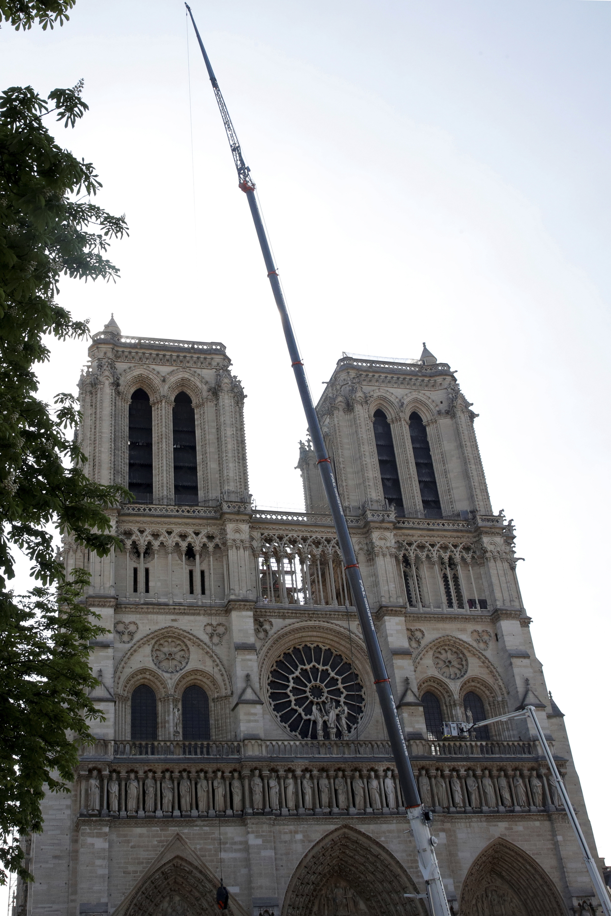 A crane works at Notre-Dame cathedral in Paris, Friday, April 19, 2019. Rebuilding Notre Dame, the 800-year-old Paris cathedral devastated by fire this week, will cost billions of dollars as architects, historians and artisans work to preserve the medieval landmark. (Philippe Wojazer/Pool via AP) A crane works at Notre-Dame cathedral in Paris, Friday, April 19, 2019. Rebuilding Notre Dame, the 800-year-old Paris cathedral devastated by fire this week, will cost billions of dollars as architects, historians and artisans work to preserve the medieval landmark. (Philippe Wojazer/Pool via AP)
