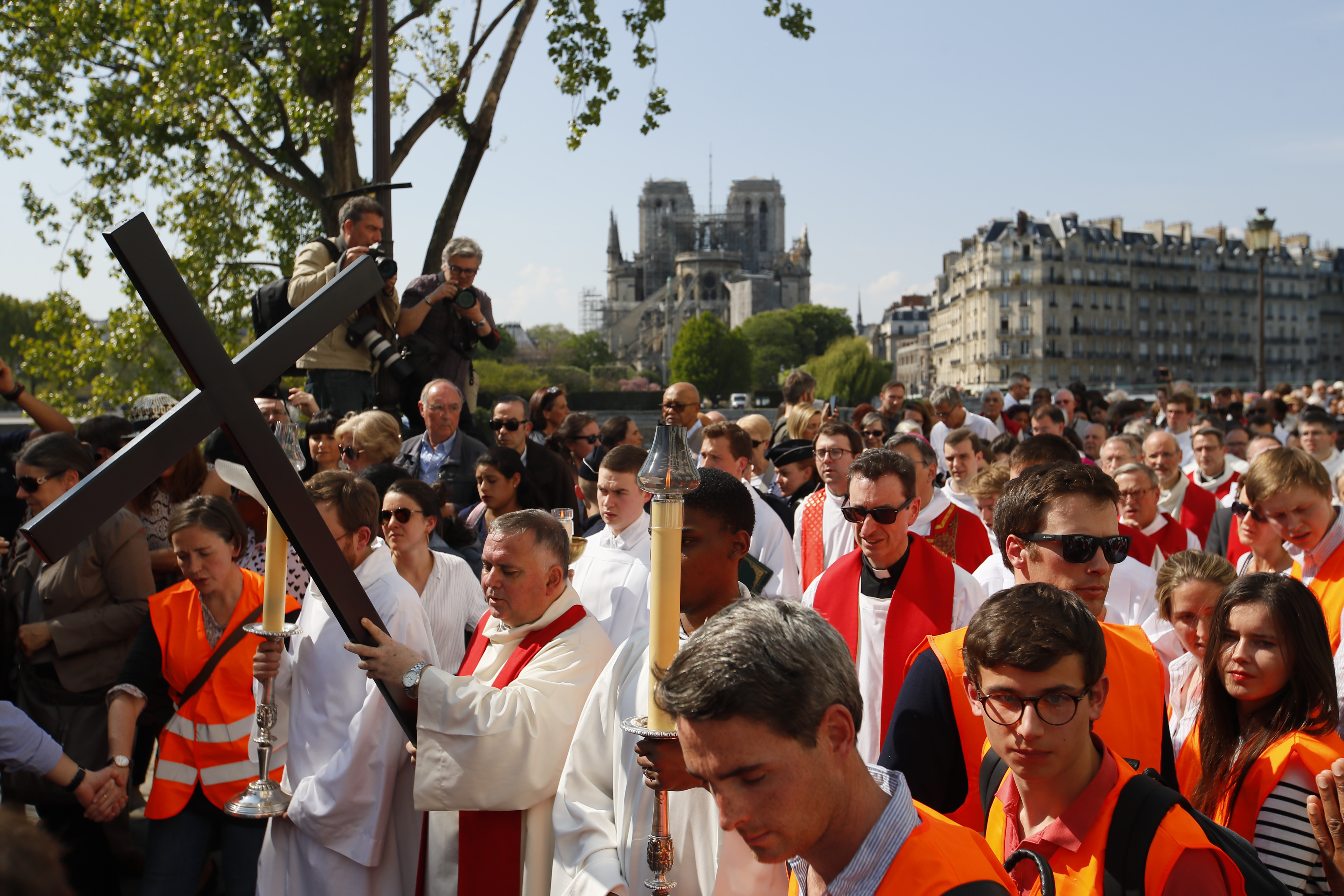 With Notre Dame cathedral in background, religious officials carry the cross during the Good Friday procession, Friday, April 19, 2019 in Paris. Top French art conservation officials say the works inside Notre Dame suffered no major damage in the fire that devastated the cathedral, and the pieces have been removed from the building for their protection.(AP Photo/Francois Mori) With Notre Dame cathedral in background, religious officials carry the cross during the Good Friday procession, Friday, April 19, 2019 in Paris. Top French art conservation officials say the works inside Notre Dame suffered no major damage in the fire that devastated the cathedral, and the pieces have been removed from the building for their protection.(AP Photo/Francois Mori)