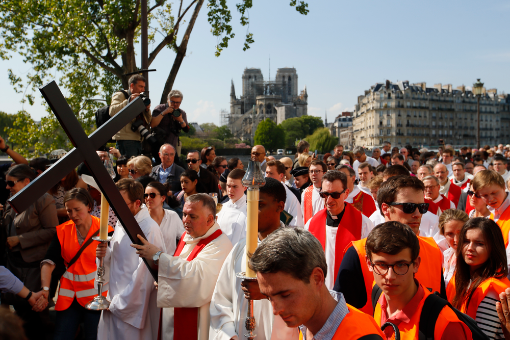With Notre Dame cathedral in background, religious officials carry the cross during the Good Friday procession, Friday, April 19, 2019 in Paris. Top French art conservation officials say the works inside Notre Dame suffered no major damage in the fire that devastated the cathedral, and the pieces have been removed from the building for their protection.(AP Photo/Francois Mori) With Notre Dame cathedral in background, religious officials carry the cross during the Good Friday procession, Friday, April 19, 2019 in Paris. Top French art conservation officials say the works inside Notre Dame suffered no major damage in the fire that devastated the cathedral, and the pieces have been removed from the building for their protection.(AP Photo/Francois Mori)