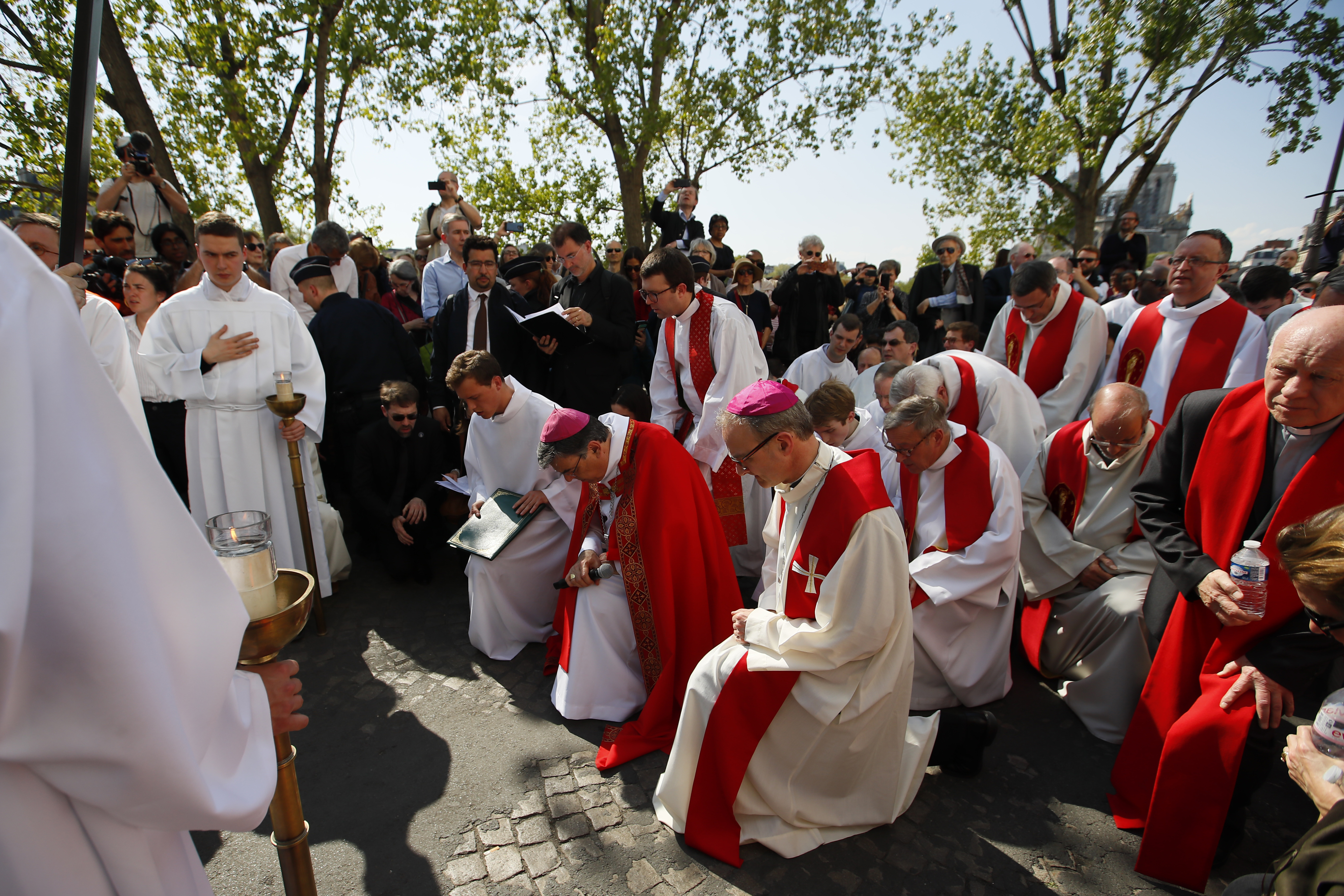With Notre Dame cathedral, background right, religious officials pray during the Good Friday procession, Friday, April 19, 2019 in Paris. Top French art conservation officials say the works inside Notre Dame suffered no major damage in the fire that devastated the cathedral, and the pieces have been removed from the building for their protection.(AP Photo/Francois Mori) With Notre Dame cathedral, background right, religious officials pray during the Good Friday procession, Friday, April 19, 2019 in Paris. Top French art conservation officials say the works inside Notre Dame suffered no major damage in the fire that devastated the cathedral, and the pieces have been removed from the building for their protection.(AP Photo/Francois Mori)