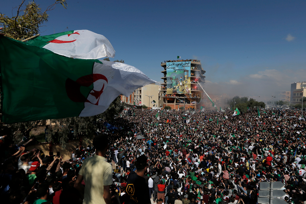 Demonstrators carry a giant Algerian flag during a protest in Bordj Bou Arreridj, east of Algiers, Friday, April 26, 2019. Algerians are massing for a 10th week of protests against their country's ruling class, calling for the ex-president's brother to be put on trial. (AP Photo/Toufik Doudou) Demonstrators carry a giant Algerian flag during a protest in Bordj Bou Arreridj, east of Algiers, Friday, April 26, 2019. Algerians are massing for a 10th week of protests against their country's ruling class, calling for the ex-president's brother to be put on trial. (AP Photo/Toufik Doudou)