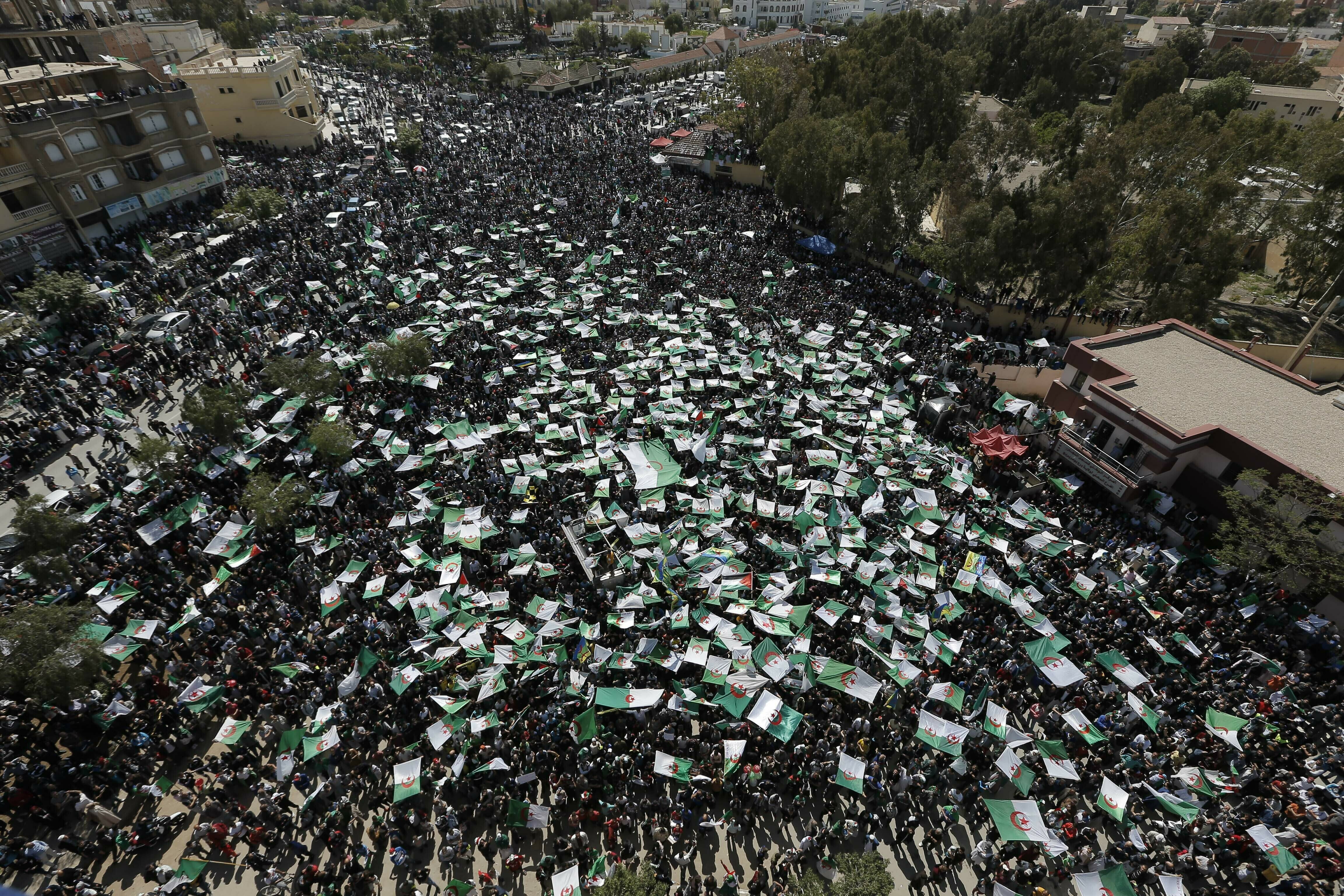 Demonstrators hold Algerian flags during a protest in Bordj Bou Arreridj, east of Algiers, Friday, April 26, 2019. Algerians are massing for a 10th week of protests against their country's ruling class, calling for the ex-president's brother to be put on trial. (AP Photo/Toufik Doudou) Demonstrators hold Algerian flags during a protest in Bordj Bou Arreridj, east of Algiers, Friday, April 26, 2019. Algerians are massing for a 10th week of protests against their country's ruling class, calling for the ex-president's brother to be put on trial. (AP Photo/Toufik Doudou)