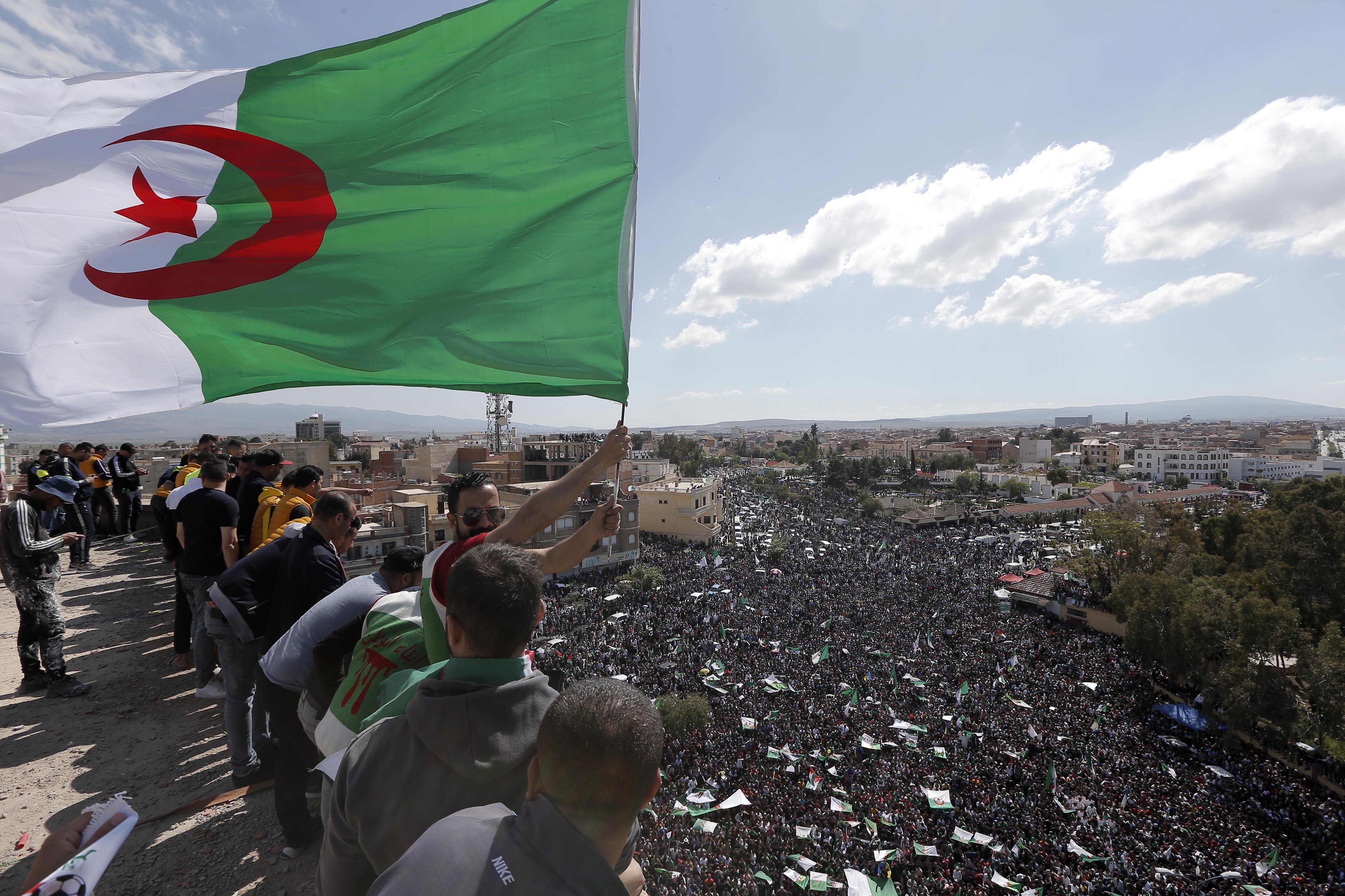 A demonstrator holds an Algerian flag during a protest in Bordj Bou Arreridj, east of Algiers, Friday, April 26, 2019. Algerians are massing for a 10th week of protests against their country's ruling class, calling for the ex-president's brother to be put on trial. (AP Photo/Toufik Doudou) A demonstrator holds an Algerian flag during a protest in Bordj Bou Arreridj, east of Algiers, Friday, April 26, 2019. Algerians are massing for a 10th week of protests against their country's ruling class, calling for the ex-president's brother to be put on trial. (AP Photo/Toufik Doudou)