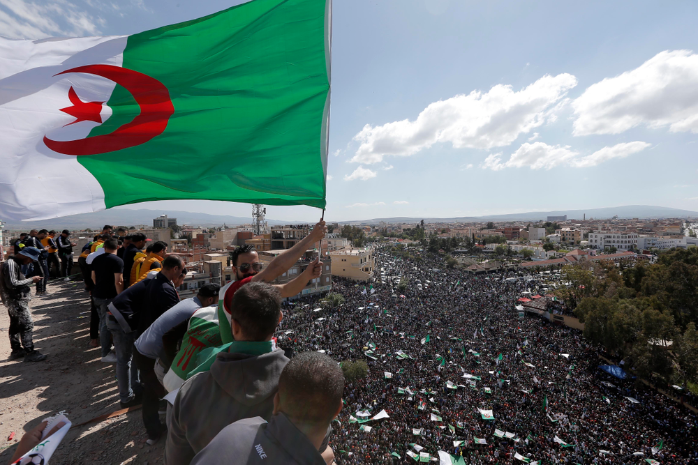 A demonstrator holds an Algerian flag during a protest in Bordj Bou Arreridj, east of Algiers, Friday, April 26, 2019. Algerians are massing for a 10th week of protests against their country's ruling class, calling for the ex-president's brother to be put on trial. (AP Photo/Toufik Doudou) A demonstrator holds an Algerian flag during a protest in Bordj Bou Arreridj, east of Algiers, Friday, April 26, 2019. Algerians are massing for a 10th week of protests against their country's ruling class, calling for the ex-president's brother to be put on trial. (AP Photo/Toufik Doudou)