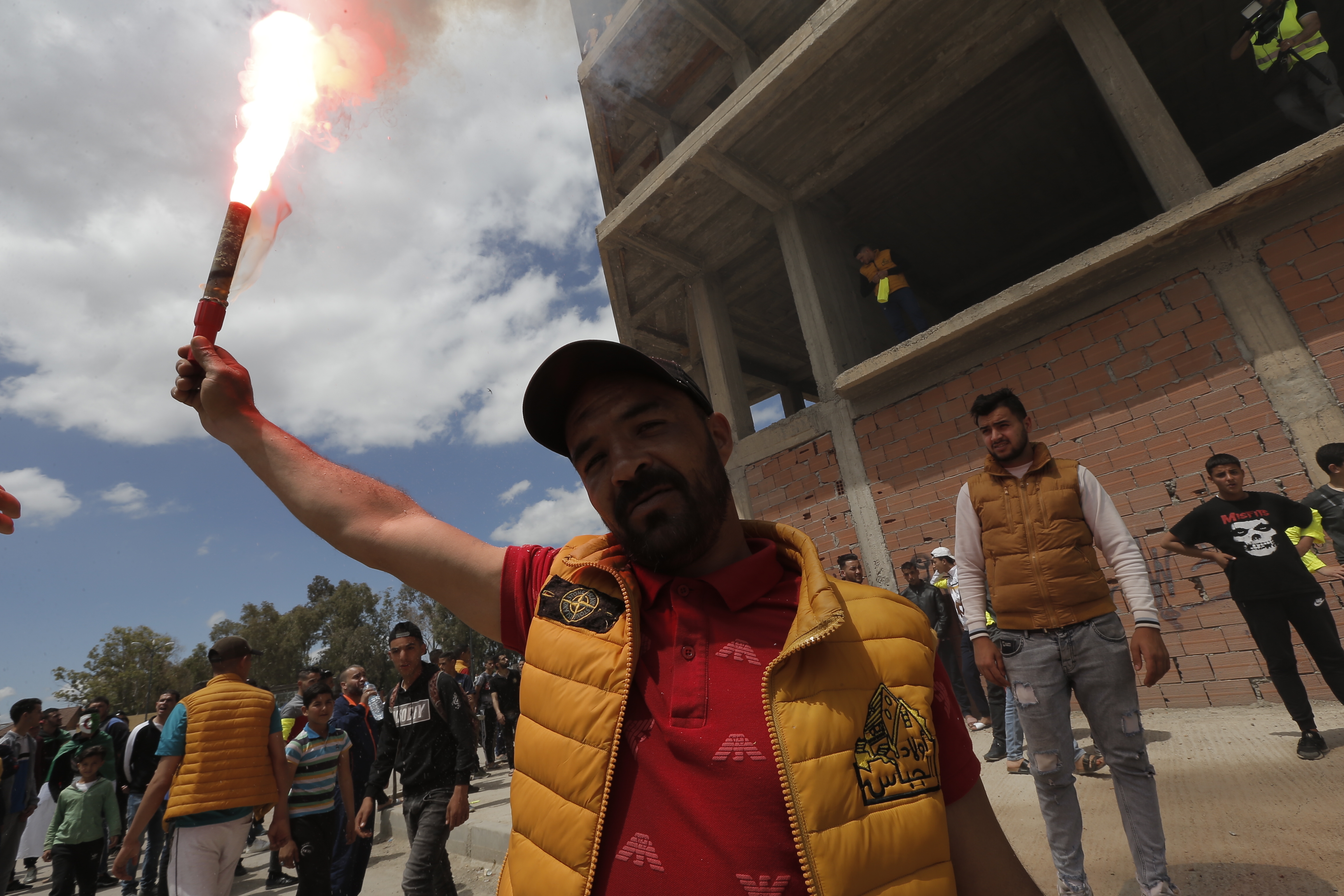 A demonstrator lights a flare during a protest in Bordj Bou Arreridj, east of Algiers, Friday, April 26, 2019. Algerians are massing for a 10th week of protests against their country's ruling class, calling for the ex-president's brother to be put on trial. (AP Photo/Toufik Doudou) A demonstrator lights a flare during a protest in Bordj Bou Arreridj, east of Algiers, Friday, April 26, 2019. Algerians are massing for a 10th week of protests against their country's ruling class, calling for the ex-president's brother to be put on trial. (AP Photo/Toufik Doudou)
