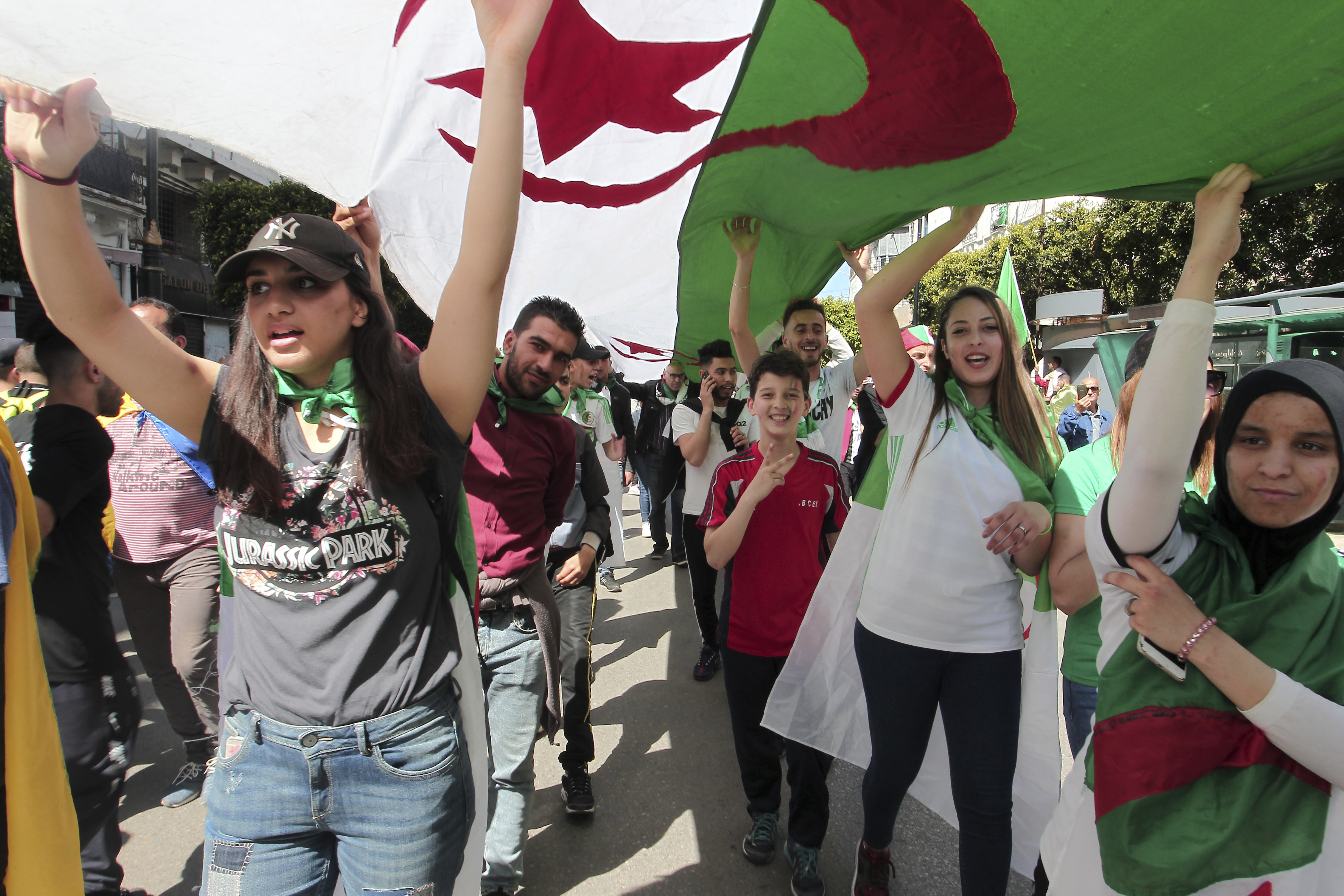 Demonstrators carry a giant Algerian flag during a protest in Algiers, Friday, April 26, 2019. Algerians are massing for a 10th week of protests against their country's ruling class, calling for the ex-president's brother to be put on trial. (AP Photo/Fateh Guidoum) Demonstrators carry a giant Algerian flag during a protest in Algiers, Friday, April 26, 2019. Algerians are massing for a 10th week of protests against their country's ruling class, calling for the ex-president's brother to be put on trial. (AP Photo/Fateh Guidoum)