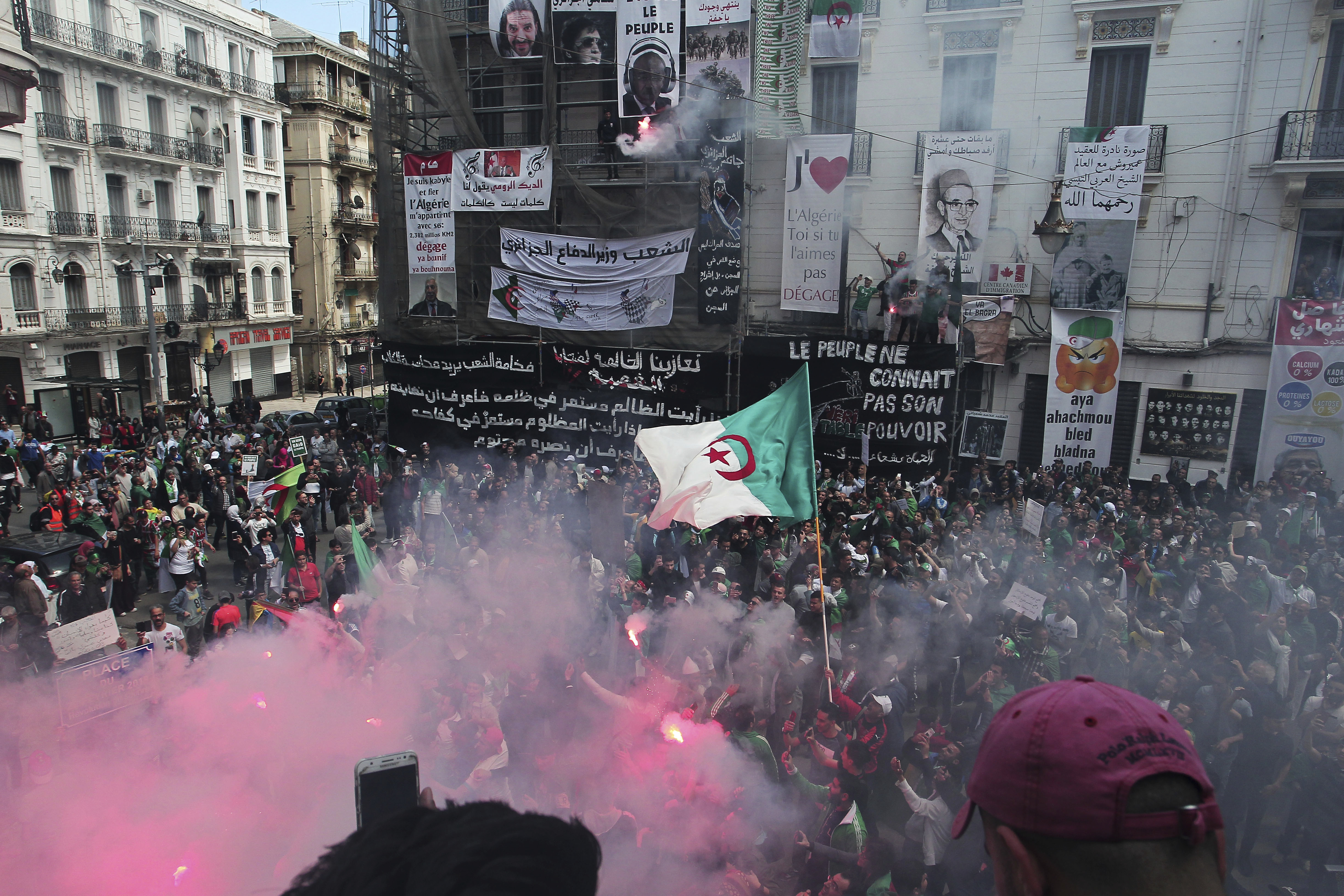 Demonstrators hold flares during a protest in Algiers, Friday, April 26, 2019. Algerians are massing for a 10th week of protests against their country's ruling class, calling for the ex-president's brother to be put on trial. (AP Photo/Fateh Guidoum) Demonstrators hold flares during a protest in Algiers, Friday, April 26, 2019. Algerians are massing for a 10th week of protests against their country's ruling class, calling for the ex-president's brother to be put on trial. (AP Photo/Fateh Guidoum)