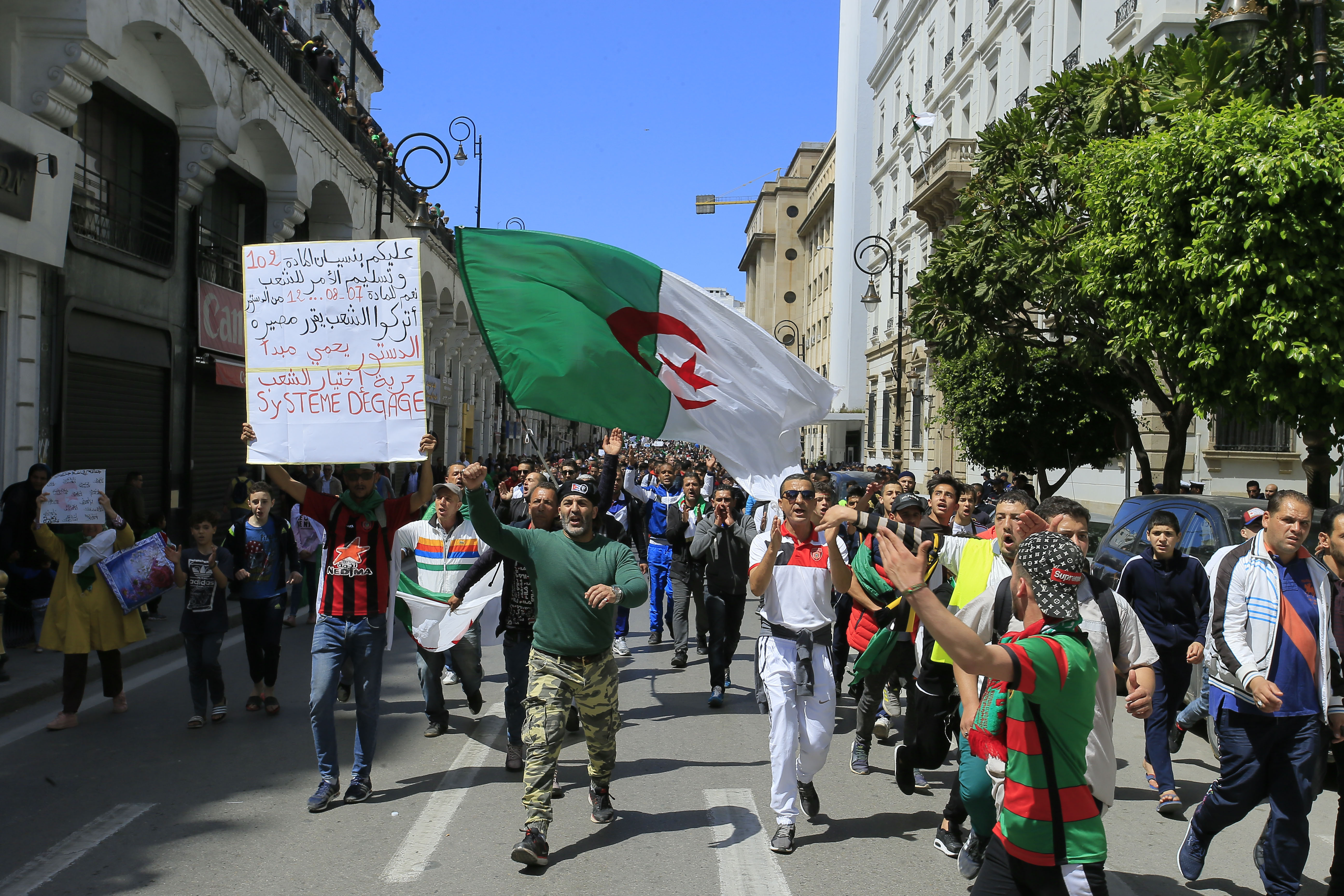 Demonstrators chant slogans during a protest in Algiers, Friday, April 26, 2019. Algerians are massing for a 10th week of protests against their country's ruling class, calling for the ex-president's brother to be put on trial. (AP Photo/Anis Belghoul) Demonstrators chant slogans during a protest in Algiers, Friday, April 26, 2019. Algerians are massing for a 10th week of protests against their country's ruling class, calling for the ex-president's brother to be put on trial. (AP Photo/Anis Belghoul)