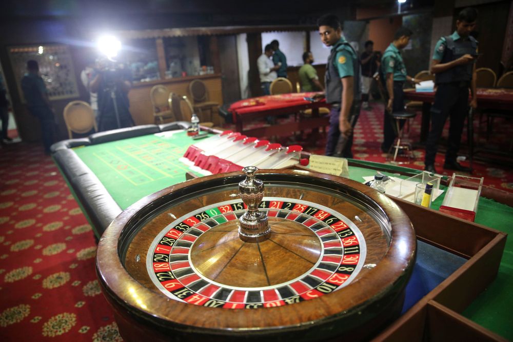 In this Sept. 22, 2019, photo, police officers inspect seized gambling equipment at Victoria Sporting Club in Dhaka, Bangladesh. Security officials in Bangladesh are on the hunt for cash, gold and illicit weapons in a crackdown Prime Minister Sheikh Hasina ordered on illegal casinos, rooting out corruption among political elites that critics say has been allowed to flourish in a troubled democracy with no effective opposition. (AP Photo/Mahmud Hossain Opu) In this Sept. 22, 2019, photo, police officers inspect seized gambling equipment at Victoria Sporting Club in Dhaka, Bangladesh. Security officials in Bangladesh are on the hunt for cash, gold and illicit weapons in a crackdown Prime Minister Sheikh Hasina ordered on illegal casinos, rooting out corruption among political elites that critics say has been allowed to flourish in a troubled democracy with no effective opposition. (AP Photo/Mahmud Hossain Opu)