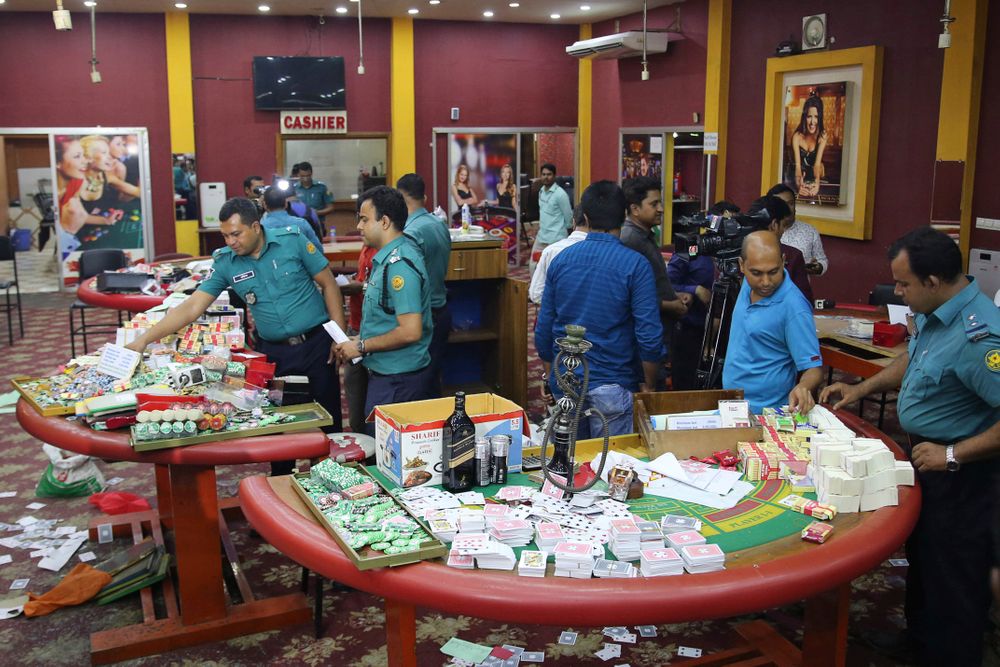In this Sept. 22, 2019, photo, police officers inspect seized gambling equipment at Victoria Sporting Club in Dhaka, Bangladesh. Security officials in Bangladesh are on the hunt for cash, gold and illicit weapons in a crackdown Prime Minister Sheikh Hasina ordered on illegal casinos, rooting out corruption among political elites that critics say has been allowed to flourish in a troubled democracy with no effective opposition. (AP Photo/Mahmud Hossain Opu) In this Sept. 22, 2019, photo, police officers inspect seized gambling equipment at Victoria Sporting Club in Dhaka, Bangladesh. Security officials in Bangladesh are on the hunt for cash, gold and illicit weapons in a crackdown Prime Minister Sheikh Hasina ordered on illegal casinos, rooting out corruption among political elites that critics say has been allowed to flourish in a troubled democracy with no effective opposition. (AP Photo/Mahmud Hossain Opu)