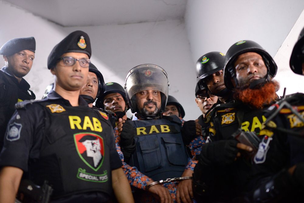 In this Oct. 6, 2019, photo, Bangladesh's ruling party member Ismail Hossain Chowdhury Samrat, accused of running a Dhaka casino empire and found with illegal drugs and liquor among other contraband, is escorted to a police station in Dhaka, Bangladesh. Security officials in Bangladesh are on the hunt for cash, gold and illicit weapons in a crackdown Prime Minister Sheikh Hasina ordered on illegal casinos, rooting out corruption among political elites that critics say has been allowed to flourish in a troubled democracy with no effective opposition. So far the punishment for those convicted has been fairly light. Samrat, was expelled from the party and sentenced to six months in jail. For the crime of money laundering alone, he could have faced up to 12 years in prison. (AP Photo/Mahmud Hossain Opu) In this Oct. 6, 2019, photo, Bangladesh's ruling party member Ismail Hossain Chowdhury Samrat, accused of running a Dhaka casino empire and found with illegal drugs and liquor among other contraband, is escorted to a police station in Dhaka, Bangladesh. Security officials in Bangladesh are on the hunt for cash, gold and illicit weapons in a crackdown Prime Minister Sheikh Hasina ordered on illegal casinos, rooting out corruption among political elites that critics say has been allowed to flourish in a troubled democracy with no effective opposition. So far the punishment for those convicted has been fairly light. Samrat, was expelled from the party and sentenced to six months in jail. For the crime of money laundering alone, he could have faced up to 12 years in prison. (AP Photo/Mahmud Hossain Opu)