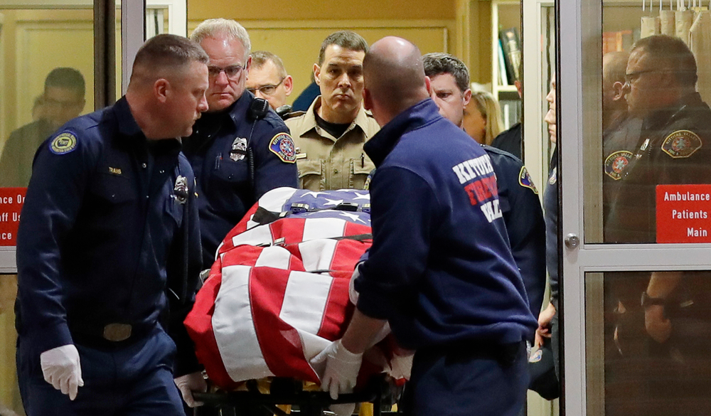 The body of a Kittitas County Sheriff's deputy is draped with a U.S. flag as it is carried out of Kittitas Valley Healthcare Hospital in the early morning hours of Wednesday, March 20, 2019, in Ellensburg, Wash. A sheriff's deputy was killed and a police officer was injured after an exchange of gunfire during an attempted traffic stop. (AP Photo/Ted S. Warren) The body of a Kittitas County Sheriff's deputy is draped with a U.S. flag as it is carried out of Kittitas Valley Healthcare Hospital in the early morning hours of Wednesday, March 20, 2019, in Ellensburg, Wash. A sheriff's deputy was killed and a police officer was injured after an exchange of gunfire during an attempted traffic stop. (AP Photo/Ted S. Warren)