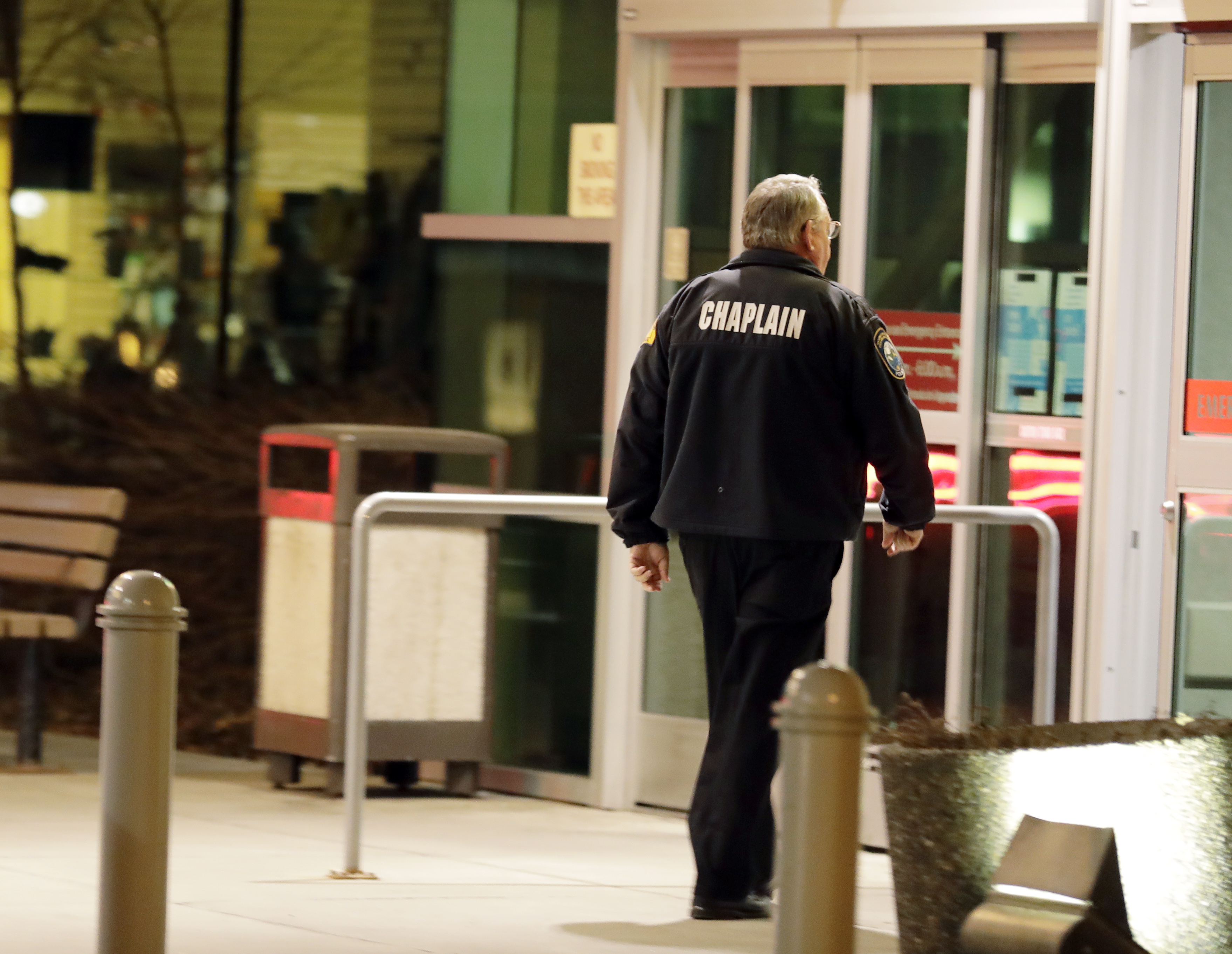 A law enforcement chaplain walks into Kittitas Valley Healthcare Hospital, in the late night hours of Tuesday, March 19, 2019, in Ellensburg, Wash., prior to a procession to accompany the body of a Kittitas County Sheriff's deputy away from the hospital. A Kittitas County Sheriff's deputy was killed and a police officer was injured after an exchange of gunfire during an attempted traffic stop. (AP Photo/Ted S. Warren) A law enforcement chaplain walks into Kittitas Valley Healthcare Hospital, in the late night hours of Tuesday, March 19, 2019, in Ellensburg, Wash., prior to a procession to accompany the body of a Kittitas County Sheriff's deputy away from the hospital. A Kittitas County Sheriff's deputy was killed and a police officer was injured after an exchange of gunfire during an attempted traffic stop. (AP Photo/Ted S. Warren)