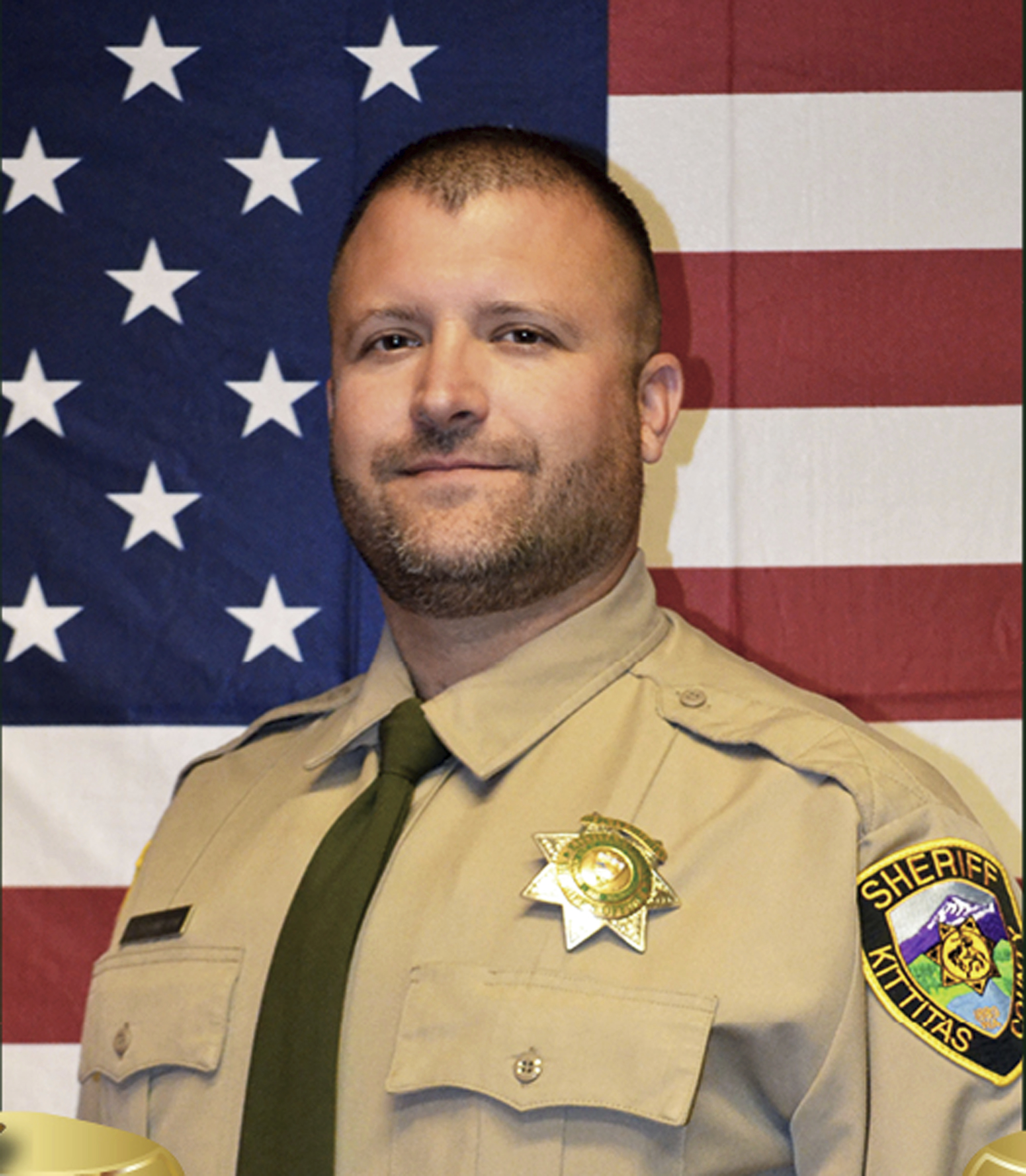 This undated photo released by the Kittitas County Sheriff's Office shows Deputy Ryan Thompson. Thompson, 42, was shot and killed and a police officer was wounded after they exchanged gunfire with a road rage driving suspect Tuesday, March 19, 2019, authorities said Wednesday, March, 20, 2019. The events unfolded Tuesday evening when the two officers tried to stop the suspect's vehicle after authorities received a complaint about the motorist's driving, authorities said. (Kittitas County Sheriff's Office via AP) This undated photo released by the Kittitas County Sheriff's Office shows Deputy Ryan Thompson. Thompson, 42, was shot and killed and a police officer was wounded after they exchanged gunfire with a road rage driving suspect Tuesday, March 19, 2019, authorities said Wednesday, March, 20, 2019. The events unfolded Tuesday evening when the two officers tried to stop the suspect's vehicle after authorities received a complaint about the motorist's driving, authorities said. (Kittitas County Sheriff's Office via AP)