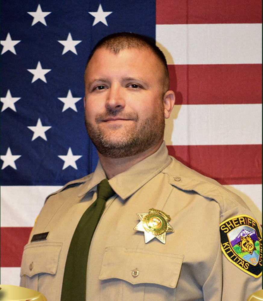 This undated photo released by the Kittitas County Sheriff's Office shows Deputy Ryan Thompson. Thompson, 42, was shot and killed and a police officer was wounded after they exchanged gunfire with a road rage driving suspect Tuesday, March 19, 2019, authorities said Wednesday, March, 20, 2019. The events unfolded Tuesday evening when the two officers tried to stop the suspect's vehicle after authorities received a complaint about the motorist's driving, authorities said. (Kittitas County Sheriff's Office via AP) This undated photo released by the Kittitas County Sheriff's Office shows Deputy Ryan Thompson. Thompson, 42, was shot and killed and a police officer was wounded after they exchanged gunfire with a road rage driving suspect Tuesday, March 19, 2019, authorities said Wednesday, March, 20, 2019. The events unfolded Tuesday evening when the two officers tried to stop the suspect's vehicle after authorities received a complaint about the motorist's driving, authorities said. (Kittitas County Sheriff's Office via AP)