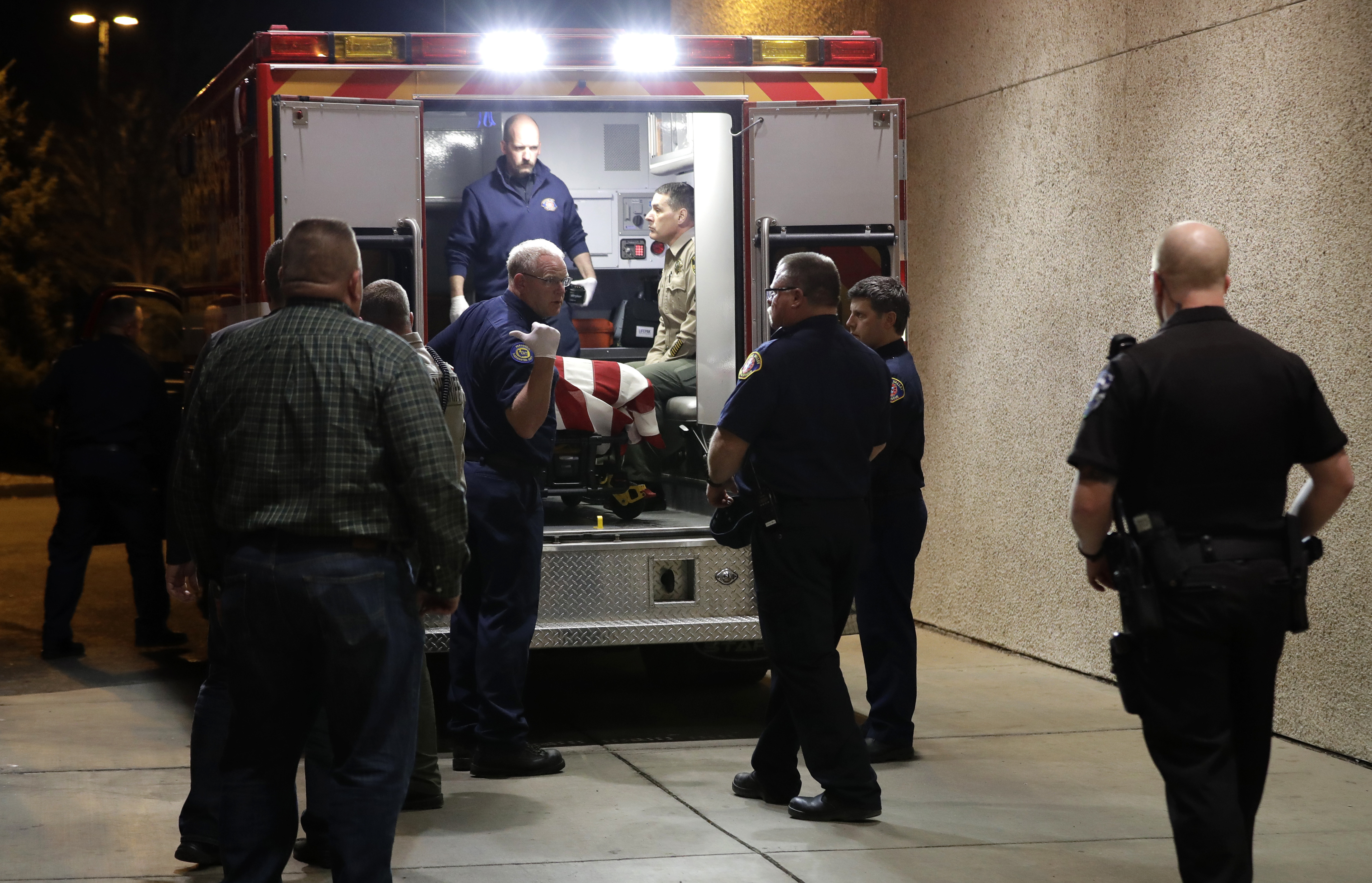 The body of a Kittitas County Sheriff's deputy is draped with a U.S. flag as it is loaded into an ambulance for a procession away from Kittitas Valley Healthcare Hospital, in the early morning hours of Wednesday, March 20, 2019, in Ellensburg, Wash. A Kittitas County Sheriff's deputy was killed and a police officer was injured after an exchange of gunfire during an attempted traffic stop. (AP Photo/Ted S. Warren) The body of a Kittitas County Sheriff's deputy is draped with a U.S. flag as it is loaded into an ambulance for a procession away from Kittitas Valley Healthcare Hospital, in the early morning hours of Wednesday, March 20, 2019, in Ellensburg, Wash. A Kittitas County Sheriff's deputy was killed and a police officer was injured after an exchange of gunfire during an attempted traffic stop. (AP Photo/Ted S. Warren)