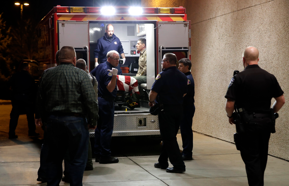 The body of a Kittitas County Sheriff's deputy is draped with a U.S. flag as it is loaded into an ambulance for a procession away from Kittitas Valley Healthcare Hospital, in the early morning hours of Wednesday, March 20, 2019, in Ellensburg, Wash. A Kittitas County Sheriff's deputy was killed and a police officer was injured after an exchange of gunfire during an attempted traffic stop. (AP Photo/Ted S. Warren) The body of a Kittitas County Sheriff's deputy is draped with a U.S. flag as it is loaded into an ambulance for a procession away from Kittitas Valley Healthcare Hospital, in the early morning hours of Wednesday, March 20, 2019, in Ellensburg, Wash. A Kittitas County Sheriff's deputy was killed and a police officer was injured after an exchange of gunfire during an attempted traffic stop. (AP Photo/Ted S. Warren)