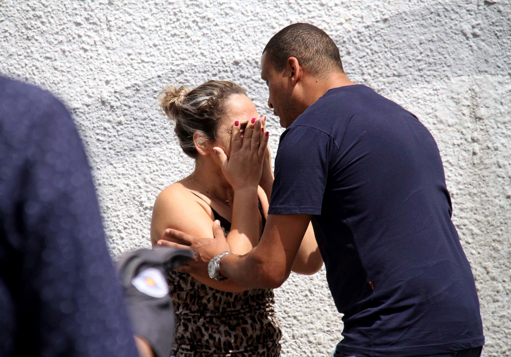 A man comforts a woman at the Raul Brasil State School in Suzano, Brazil, Wednesday, March 13, 2019. The state government of Sao Paulo said two teenagers, armed with guns and wearing hoods, entered the school and began shooting at students. They then killed themselves, according to the statement. (Mauricio Sumiya/Futura Press via AP) A man comforts a woman at the Raul Brasil State School in Suzano, Brazil, Wednesday, March 13, 2019. The state government of Sao Paulo said two teenagers, armed with guns and wearing hoods, entered the school and began shooting at students. They then killed themselves, according to the statement. (Mauricio Sumiya/Futura Press via AP)