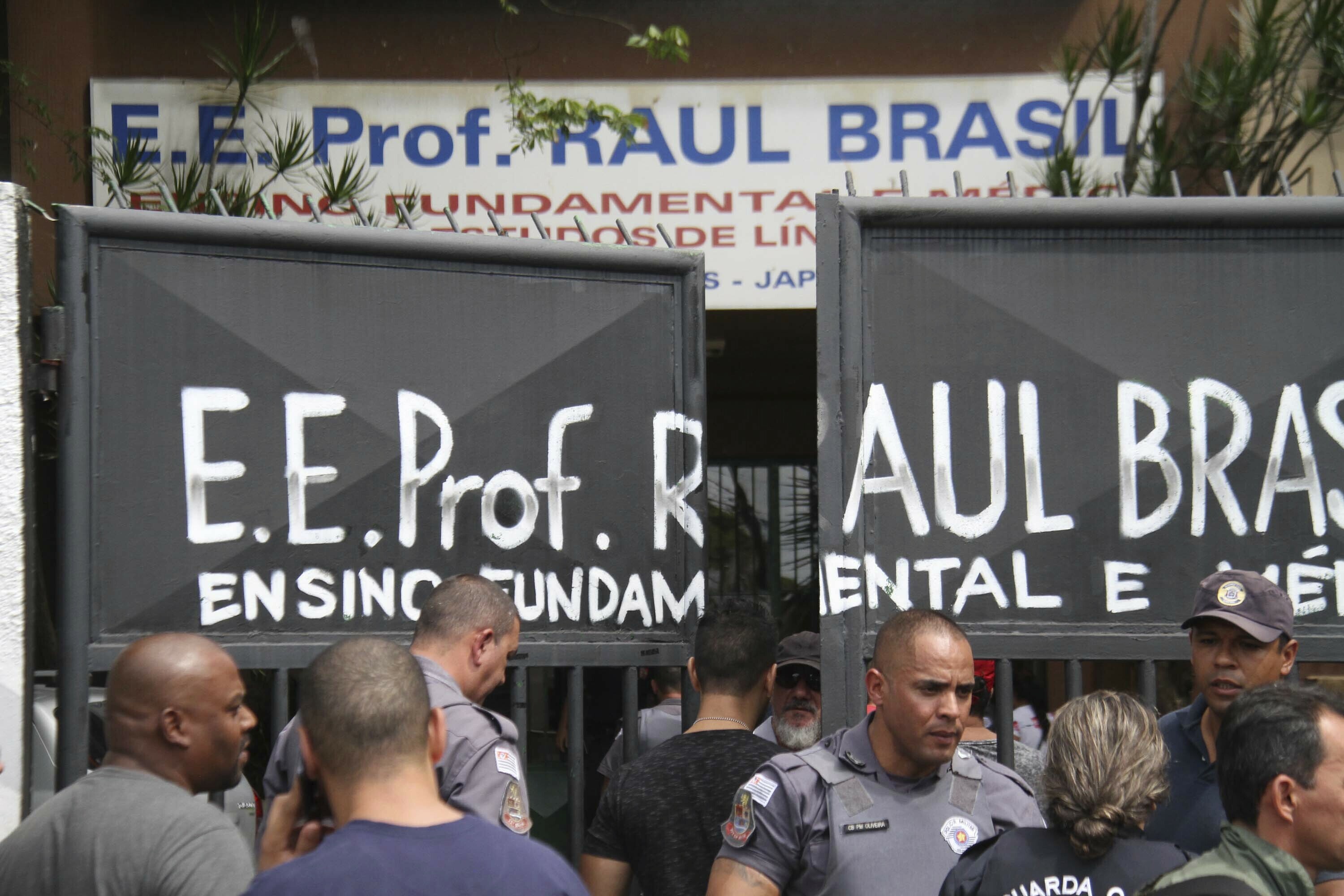 Police officers guard the entrance of the Raul Brasil State School in Suzano, Brazil, Wednesday, March 13, 2019. The state government of Sao Paulo said two teenagers, armed with guns and wearing hoods, entered the school and began shooting at students. They then killed themselves, according to the statement. (Mauricio Sumiya/Futura Press via AP) Police officers guard the entrance of the Raul Brasil State School in Suzano, Brazil, Wednesday, March 13, 2019. The state government of Sao Paulo said two teenagers, armed with guns and wearing hoods, entered the school and began shooting at students. They then killed themselves, according to the statement. (Mauricio Sumiya/Futura Press via AP)