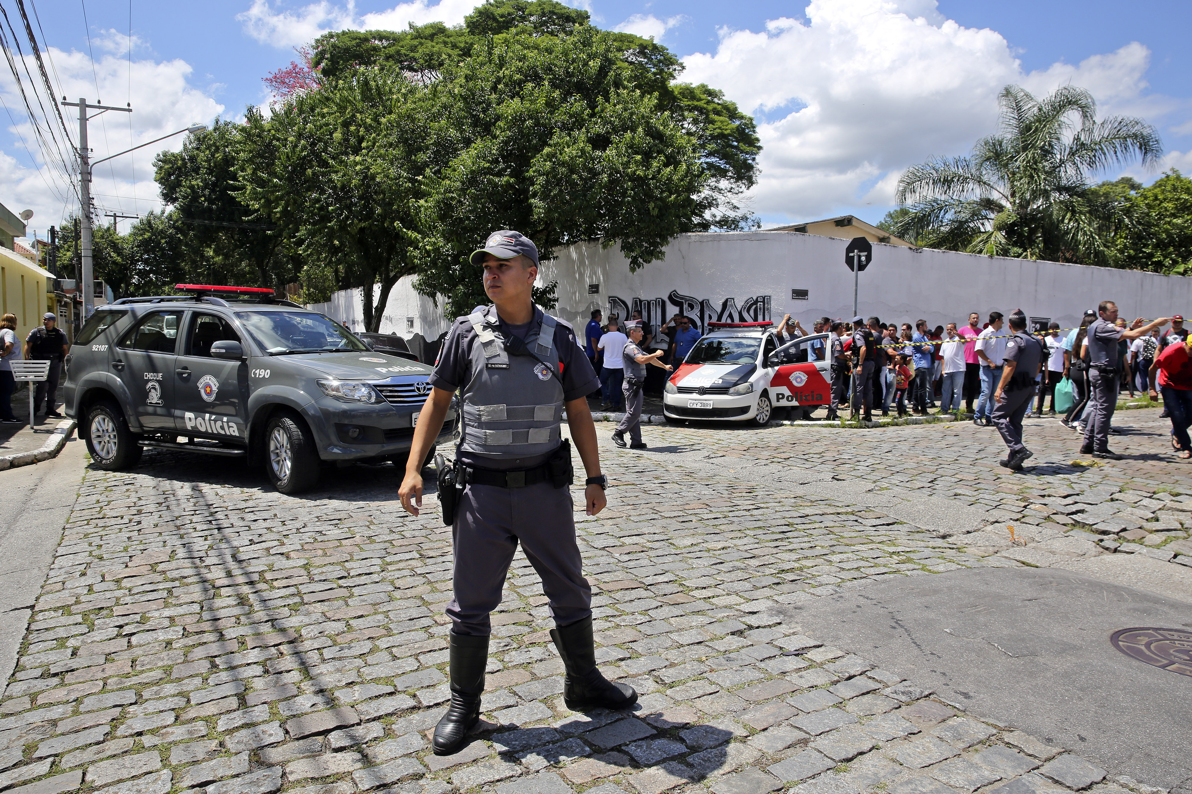 Police officers stand guard outside the Raul Brasil State School in Suzano, the greater Sao Paulo area, Brazil, Wednesday, March 13, 2019. The state government of Sao Paulo said two teenagers, armed with guns and wearing hoods, entered the school and began shooting at students. They then killed themselves, according to the statement. (AP Photo/Andre Penner) Police officers stand guard outside the Raul Brasil State School in Suzano, the greater Sao Paulo area, Brazil, Wednesday, March 13, 2019. The state government of Sao Paulo said two teenagers, armed with guns and wearing hoods, entered the school and began shooting at students. They then killed themselves, according to the statement. (AP Photo/Andre Penner)