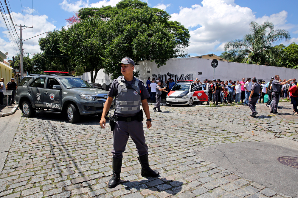 Police officers stand guard outside the Raul Brasil State School in Suzano, the greater Sao Paulo area, Brazil, Wednesday, March 13, 2019. The state government of Sao Paulo said two teenagers, armed with guns and wearing hoods, entered the school and began shooting at students. They then killed themselves, according to the statement. (AP Photo/Andre Penner) Police officers stand guard outside the Raul Brasil State School in Suzano, the greater Sao Paulo area, Brazil, Wednesday, March 13, 2019. The state government of Sao Paulo said two teenagers, armed with guns and wearing hoods, entered the school and began shooting at students. They then killed themselves, according to the statement. (AP Photo/Andre Penner)