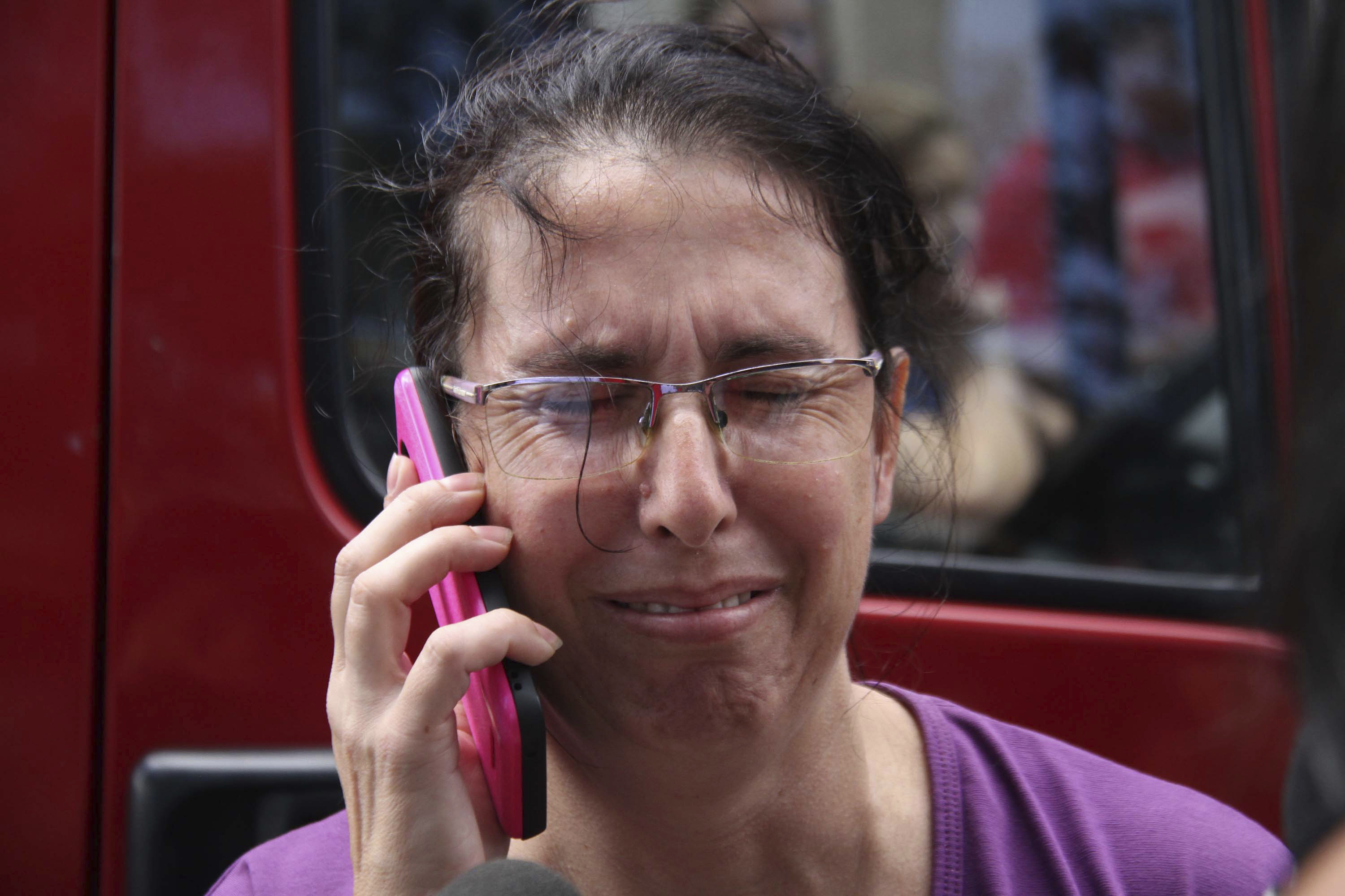 A woman uses her cell phone as she waits for news outside the Raul Brasil State School in Suzano, Sao Paulo state, Brazil, Wednesday, March 13, 2019. The state government of Sao Paulo said two teenagers, armed with guns and wearing hoods, entered the school and began shooting at students. They then killed themselves, according to the statement. (Mauricio Sumiya/Futura Press via AP) A woman uses her cell phone as she waits for news outside the Raul Brasil State School in Suzano, Sao Paulo state, Brazil, Wednesday, March 13, 2019. The state government of Sao Paulo said two teenagers, armed with guns and wearing hoods, entered the school and began shooting at students. They then killed themselves, according to the statement. (Mauricio Sumiya/Futura Press via AP)