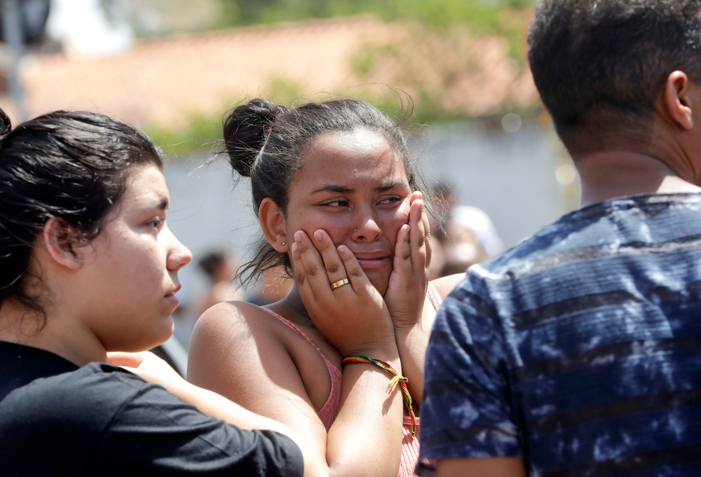 A student cries outside the Raul Brasil State School in Suzano, the greater Sao Paulo area, Brazil, Wednesday, March 13, 2019. The state government of Sao Paulo said two teenagers, armed with guns and wearing hoods, entered the school and began shooting at students. They then killed themselves, according to the statement. (AP Photo/Andre Penner) A student cries outside the Raul Brasil State School in Suzano, the greater Sao Paulo area, Brazil, Wednesday, March 13, 2019. The state government of Sao Paulo said two teenagers, armed with guns and wearing hoods, entered the school and began shooting at students. They then killed themselves, according to the statement. (AP Photo/Andre Penner)