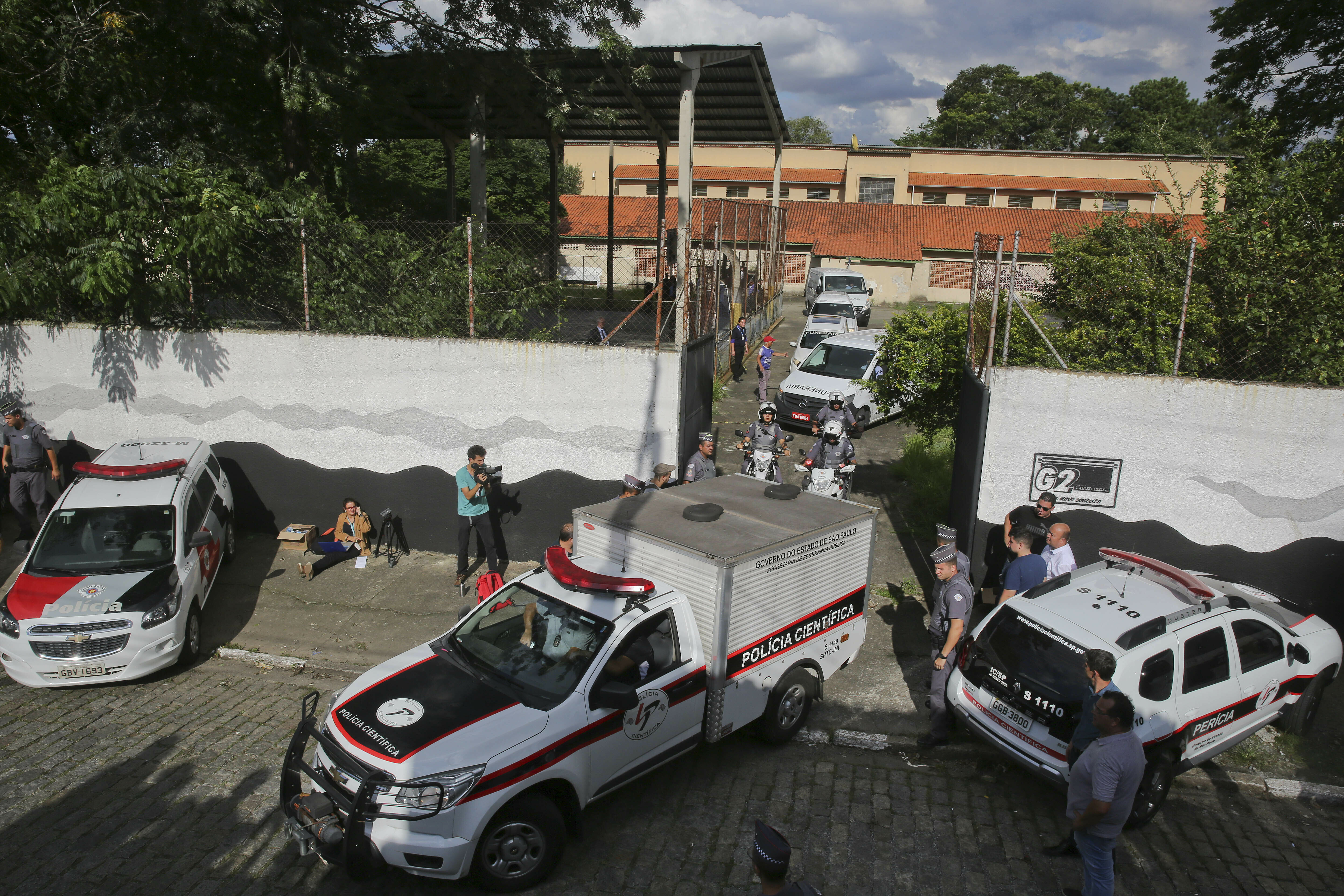Forensic vehicles transport the bodies of the people who were killed in a school shooting at the Raul Brasil State School in Suzano, in the greater Sao Paulo area, Brazil, Wednesday, March 13, 2019. Two masked former students armed with guns, knives, axes and crossbows descended on the school Wednesday, killing five students and two adults before taking their own lives, authorities said. (AP Photo/Andre Penner) Forensic vehicles transport the bodies of the people who were killed in a school shooting at the Raul Brasil State School in Suzano, in the greater Sao Paulo area, Brazil, Wednesday, March 13, 2019. Two masked former students armed with guns, knives, axes and crossbows descended on the school Wednesday, killing five students and two adults before taking their own lives, authorities said. (AP Photo/Andre Penner)