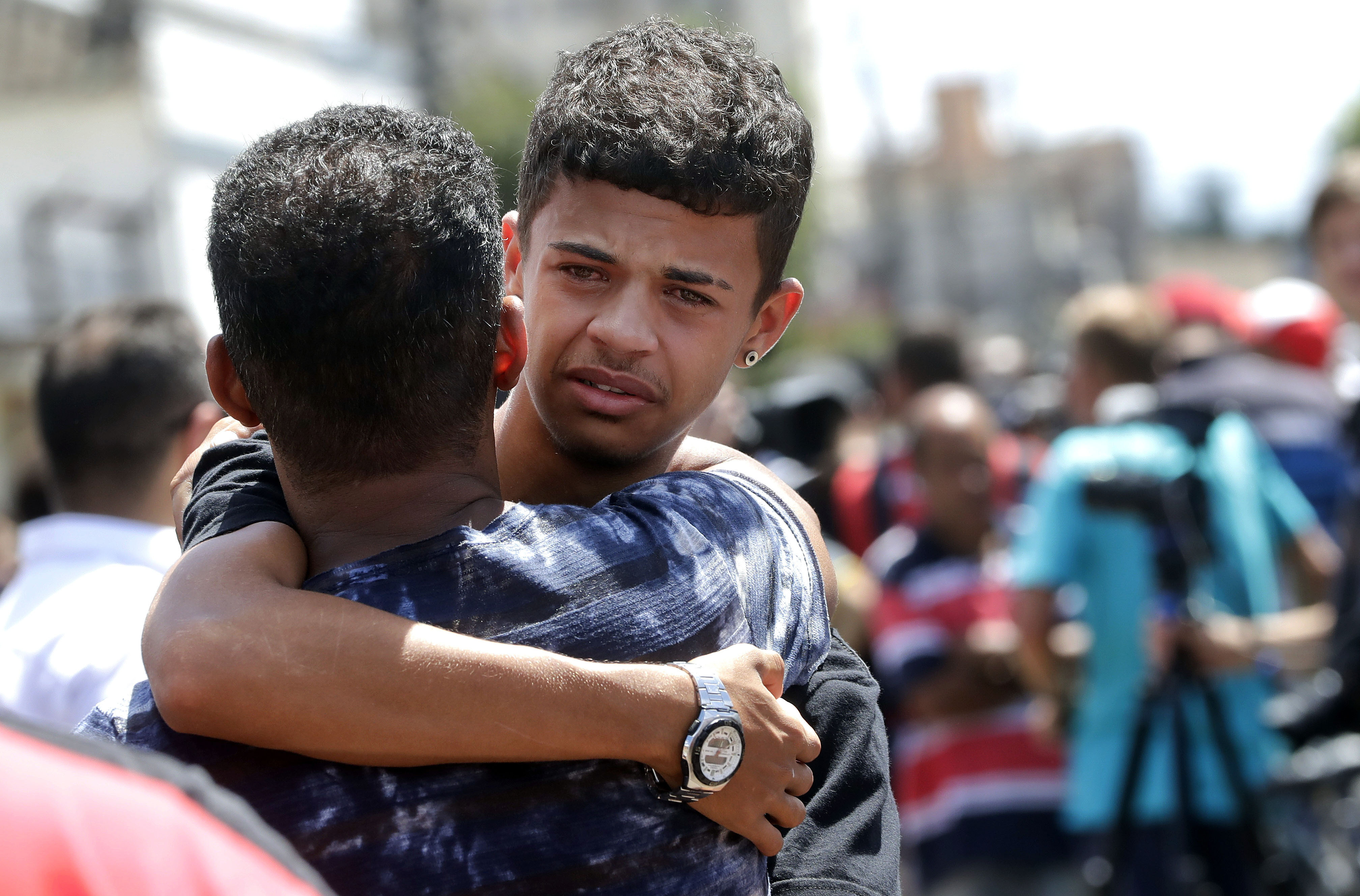 A former student is comforted by a friend outside the Raul Brasil State School in Suzano, the greater Sao Paulo area, Brazil, Wednesday, March 13, 2019. The state government of Sao Paulo said two teenagers, armed with guns and wearing hoods, entered the school and began shooting at students. They then killed themselves, according to the statement. (AP Photo/Andre Penner) A former student is comforted by a friend outside the Raul Brasil State School in Suzano, the greater Sao Paulo area, Brazil, Wednesday, March 13, 2019. The state government of Sao Paulo said two teenagers, armed with guns and wearing hoods, entered the school and began shooting at students. They then killed themselves, according to the statement. (AP Photo/Andre Penner)