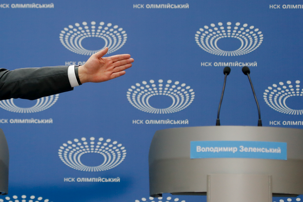 Ukrainian President Petro Poroshenko gestures toward a tribune with Volodymyr Zelenskiy's name written on it, as he answers a journalist's question ahead of the presidential elections on April 21, at the Olympic stadium in Kiev, Ukraine, Sunday, April 14, 2019. Zelenskiy, who's never held office, challenged Poroshenko to take part in a debate in the stadium two days before the election, but Poroshenko wanted it to be held Sunday. (AP Photo/Efrem Lukatsky) Ukrainian President Petro Poroshenko gestures toward a tribune with Volodymyr Zelenskiy's name written on it, as he answers a journalist's question ahead of the presidential elections on April 21, at the Olympic stadium in Kiev, Ukraine, Sunday, April 14, 2019. Zelenskiy, who's never held office, challenged Poroshenko to take part in a debate in the stadium two days before the election, but Poroshenko wanted it to be held Sunday. (AP Photo/Efrem Lukatsky)