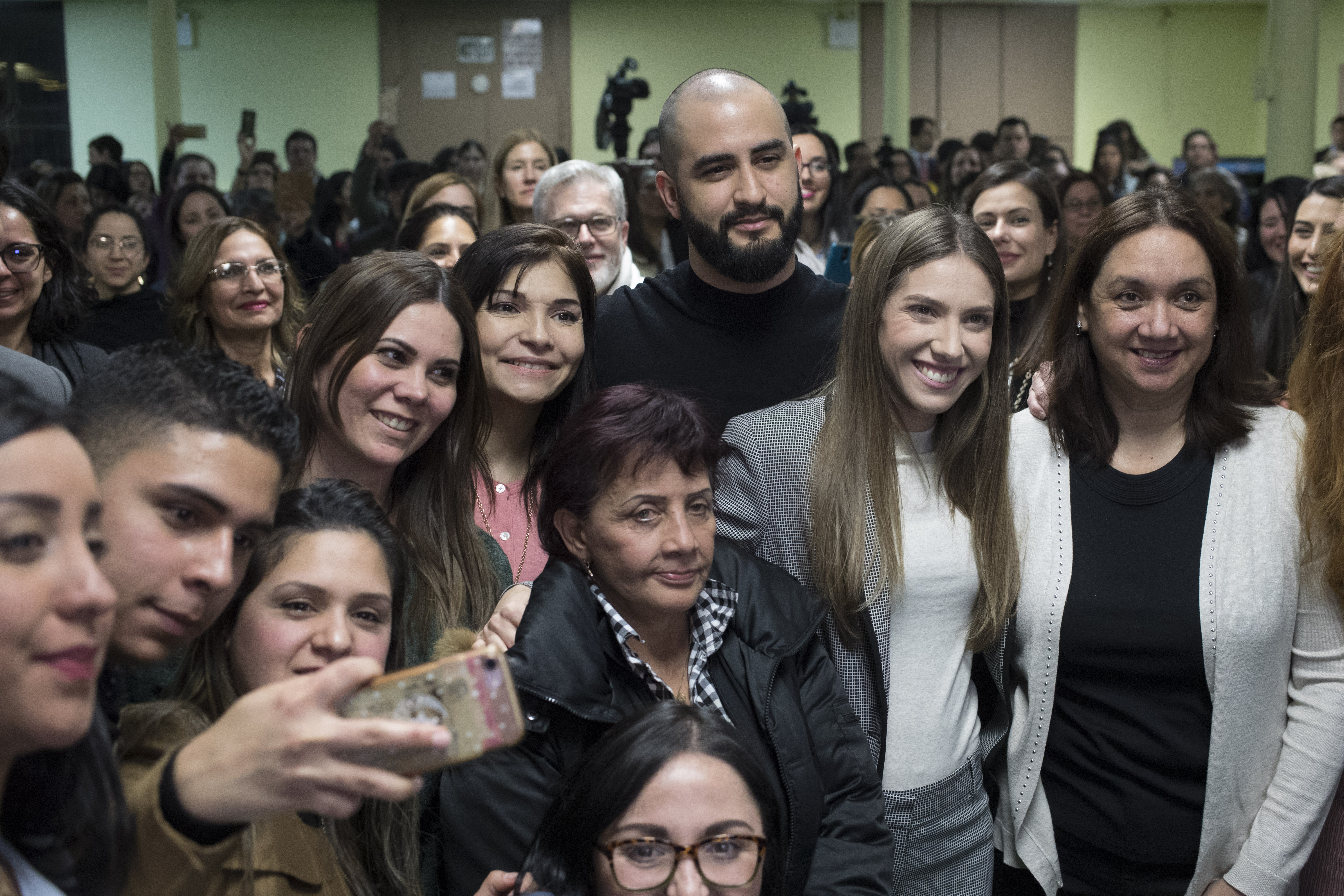 Fabiana Rosales, second from right, wife of Venezuelan opposition leader Juan Guaido, and Aminta Perez, third from right, mother of Venezuelan police Officer Oscar Perez, pose for a photo with members of the Venezuelan community in New York after attending Mass at St. Teresa's Church on the Lower East Side of Manhattan, Tuesday, March 26, 2019. Rosales is emerging as a prominent figure in Guaido's campaign to bring change in the crisis-wracked country. (AP Photo/Mary Altaffer) Fabiana Rosales, second from right, wife of Venezuelan opposition leader Juan Guaido, and Aminta Perez, third from right, mother of Venezuelan police Officer Oscar Perez, pose for a photo with members of the Venezuelan community in New York after attending Mass at St. Teresa's Church on the Lower East Side of Manhattan, Tuesday, March 26, 2019. Rosales is emerging as a prominent figure in Guaido's campaign to bring change in the crisis-wracked country. (AP Photo/Mary Altaffer)