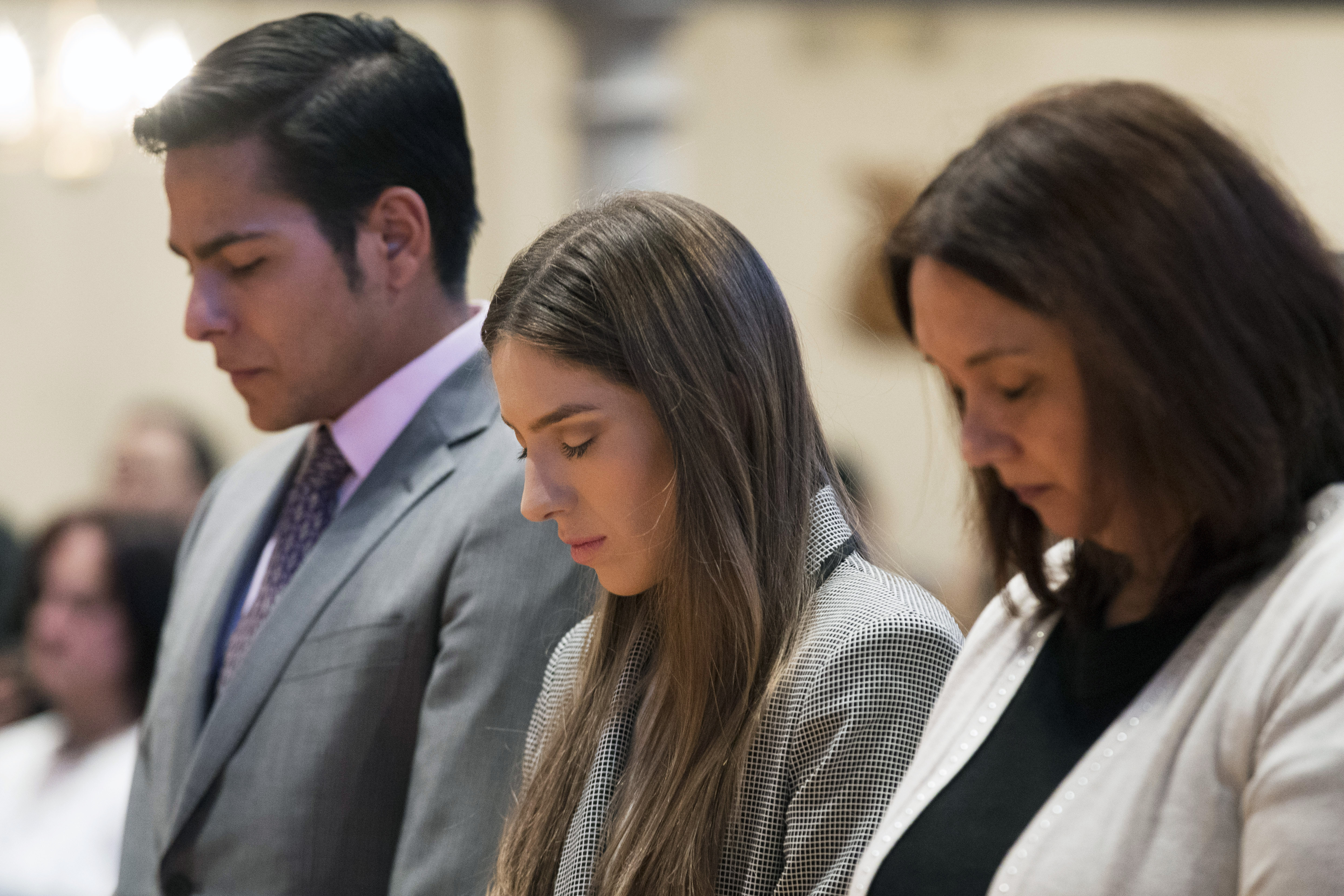 Fabiana Rosales, center, wife of Venezuelan opposition leader Juan Guaido, and Guaido supporter and activist Erick Rozo, left, pray while celebrating Mass at St. Teresa's Church on the Lower East Side of Manhattan, Tuesday, March 26, 2019, in New York. Rosales is emerging as a prominent figure in Guaido's campaign to bring change in the crisis-wracked country. (AP Photo/Mary Altaffer) Fabiana Rosales, center, wife of Venezuelan opposition leader Juan Guaido, and Guaido supporter and activist Erick Rozo, left, pray while celebrating Mass at St. Teresa's Church on the Lower East Side of Manhattan, Tuesday, March 26, 2019, in New York. Rosales is emerging as a prominent figure in Guaido's campaign to bring change in the crisis-wracked country. (AP Photo/Mary Altaffer)
