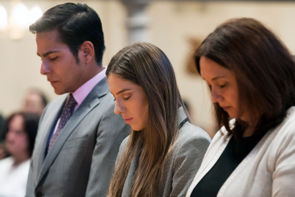 Fabiana Rosales, center, wife of Venezuelan opposition leader Juan Guaido, and Guaido supporter and activist Erick Rozo, left, pray while celebrating Mass at St. Teresa's Church on the Lower East Side of Manhattan, Tuesday, March 26, 2019, in New York. Rosales is emerging as a prominent figure in Guaido's campaign to bring change in the crisis-wracked country. (AP Photo/Mary Altaffer) Fabiana Rosales, center, wife of Venezuelan opposition leader Juan Guaido, and Guaido supporter and activist Erick Rozo, left, pray while celebrating Mass at St. Teresa's Church on the Lower East Side of Manhattan, Tuesday, March 26, 2019, in New York. Rosales is emerging as a prominent figure in Guaido's campaign to bring change in the crisis-wracked country. (AP Photo/Mary Altaffer)