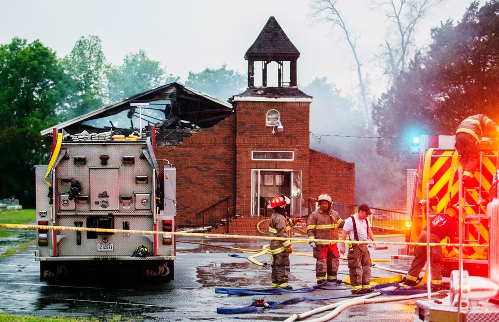FILE - In this April 4, 2019 file photo, firefighters and fire investigators respond to a fire at Mt. Pleasant Baptist Church, in Opelousas, La. Authorities have arrested a person in connection with suspicious fires at three historic black churches in southern Louisiana, a federal prosecutor said. The suspect was in state custody, U.S. Attorney David C. Joseph announced late Wednesday, April 10 in a news release labeling the fires “despicable acts.” (Leslie Westbrook/The Advocate via AP, File) FILE - In this April 4, 2019 file photo, firefighters and fire investigators respond to a fire at Mt. Pleasant Baptist Church, in Opelousas, La. Authorities have arrested a person in connection with suspicious fires at three historic black churches in southern Louisiana, a federal prosecutor said. The suspect was in state custody, U.S. Attorney David C. Joseph announced late Wednesday, April 10 in a news release labeling the fires “despicable acts.” (Leslie Westbrook/The Advocate via AP, File)