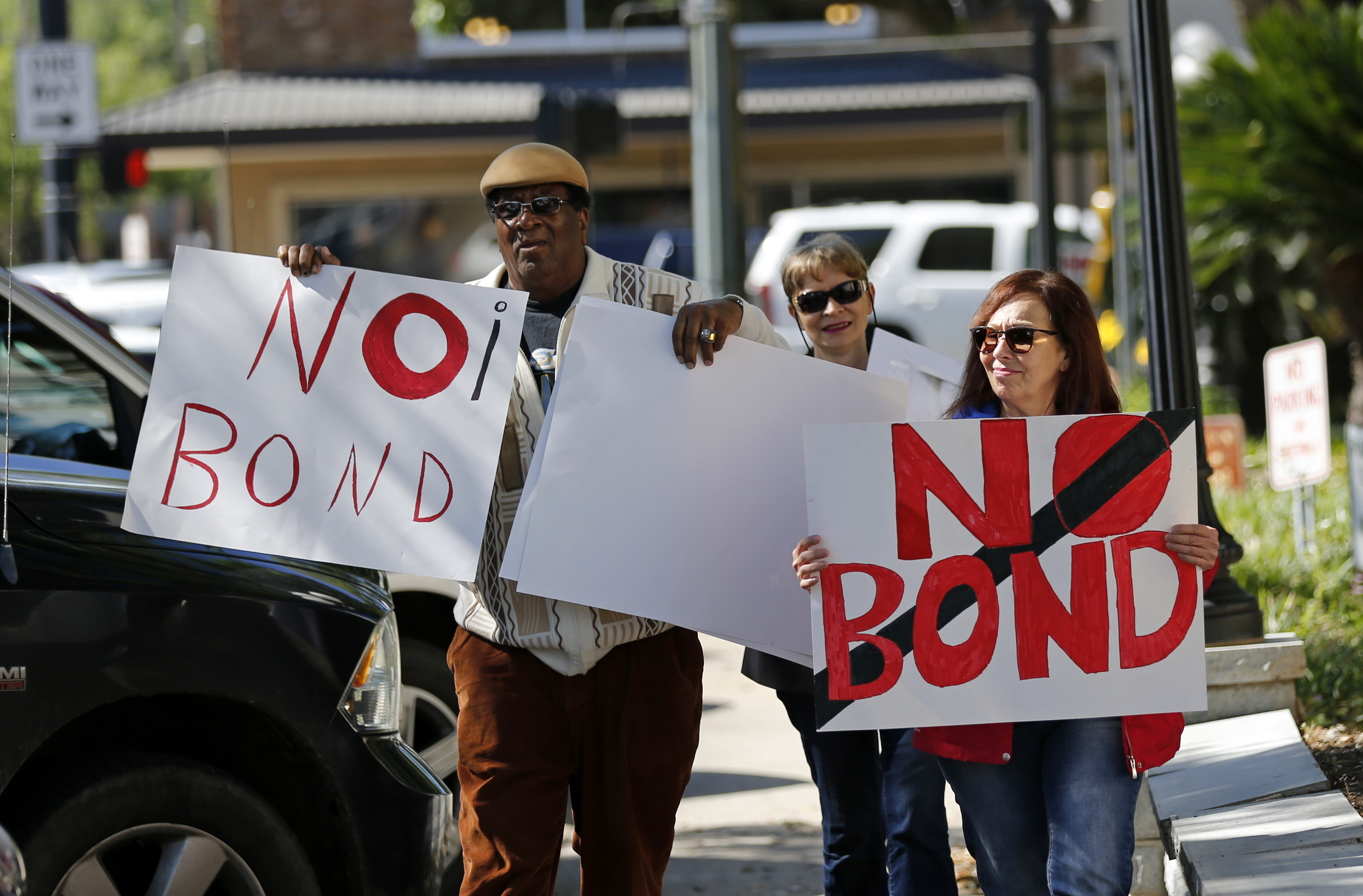 Wilfred Young, Agnes Courbille, center, and Karel Anne Zibe, right, of the St. Landry Parish branch of the NAACP, carry signs outside the St. Landry Parish courthouse after a bond hearing for Holden Matthews in Opelousas, La., Monday, April 15, 2019. Matthews, who is white, and is the son of a St. Landry Parish sheriff's deputy, was arrested Wednesday on three charges of arson of a religious building, and is the suspect in three recent arson fires that destroyed African American churches in Louisiana. (AP Photo/Gerald Herbert) Wilfred Young, Agnes Courbille, center, and Karel Anne Zibe, right, of the St. Landry Parish branch of the NAACP, carry signs outside the St. Landry Parish courthouse after a bond hearing for Holden Matthews in Opelousas, La., Monday, April 15, 2019. Matthews, who is white, and is the son of a St. Landry Parish sheriff's deputy, was arrested Wednesday on three charges of arson of a religious building, and is the suspect in three recent arson fires that destroyed African American churches in Louisiana. (AP Photo/Gerald Herbert)