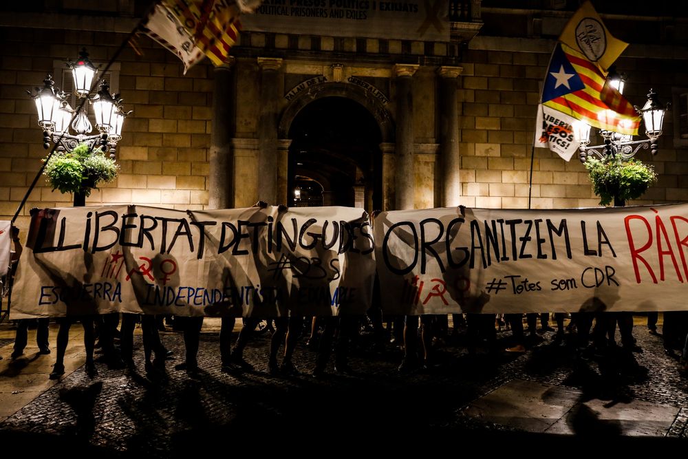 CORRECTS PHOTOGRAPHER NAME - Members of the self-proclaimed Committees for the Defense of the Republic or CDR protest against the detention of seven Catalan independence supporters during a demonstration in Sant Jaume square, Barcelona, Spain, Thursday, Sept. 26, 2019. Spain's National Court says a judge is sending to jail seven Catalan independence supporters who were arrested this week for allegedly planning violent acts, possibly with explosives. A court statement says an investigating judge has found signs that the seven could be part of an organization that intends to use CORRECTS PHOTOGRAPHER NAME - Members of the self-proclaimed Committees for the Defense of the Republic or CDR protest against the detention of seven Catalan independence supporters during a demonstration in Sant Jaume square, Barcelona, Spain, Thursday, Sept. 26, 2019. Spain's National Court says a judge is sending to jail seven Catalan independence supporters who were arrested this week for allegedly planning violent acts, possibly with explosives. A court statement says an investigating judge has found signs that the seven could be part of an organization that intends to use
